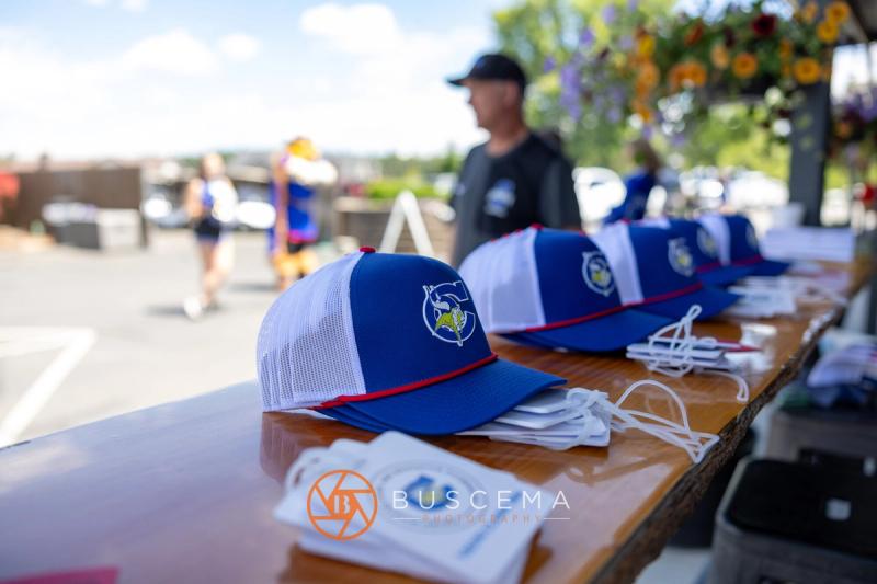 Viking Golf Classic hats and gloves laid out at the check-in table