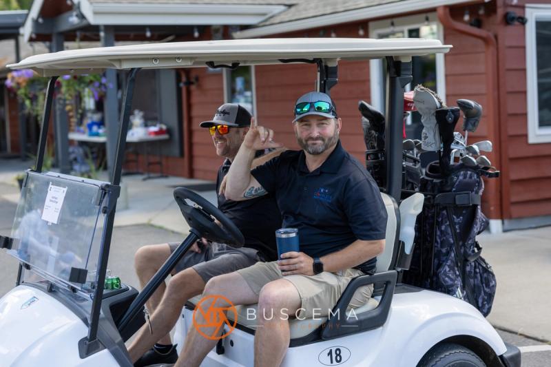 Two golfers in cart 18 ready to roll out