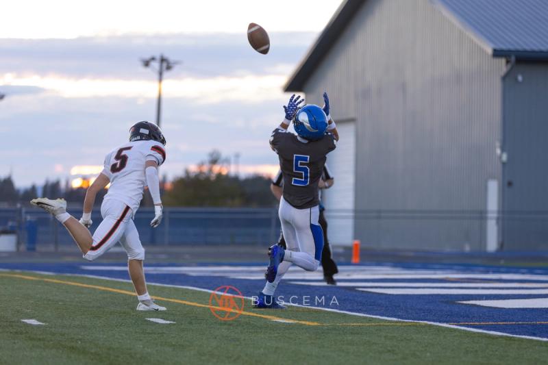 Coeur d'Alene number 5 leaping for a pass with a Lewis and Clark defender trailing
