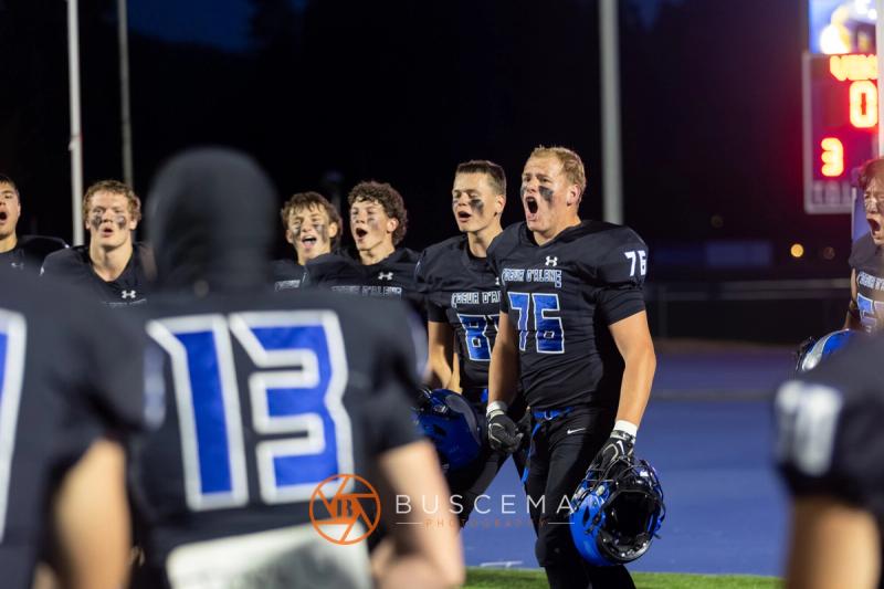 The Coeur d'Alene sideline erupts during the Rigby game
