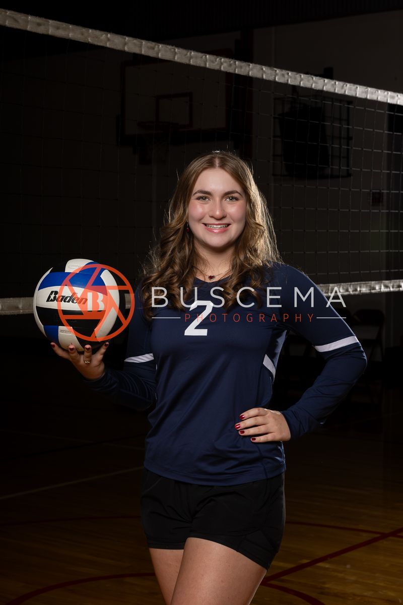 Coeur du Christ Academy volleyball player in a number 2 jersey holding a volleyball