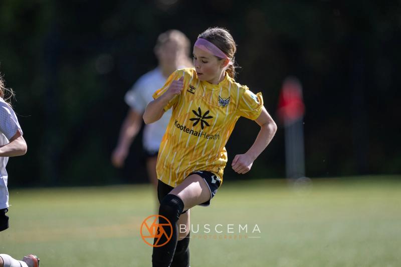 Sting 13G Academy player in a pink headband running upfield