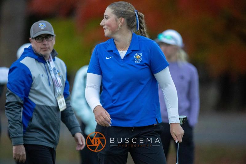 Smiling Coeur d'Alene girls golfer with her coach after the round at the 6A state golf championships at Avondale Golf Club