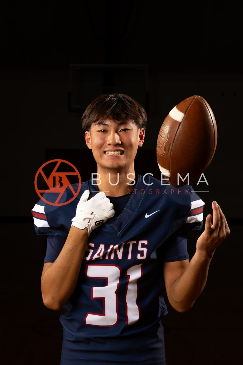 Coeur du Christ Academy football player tossing a football in the air