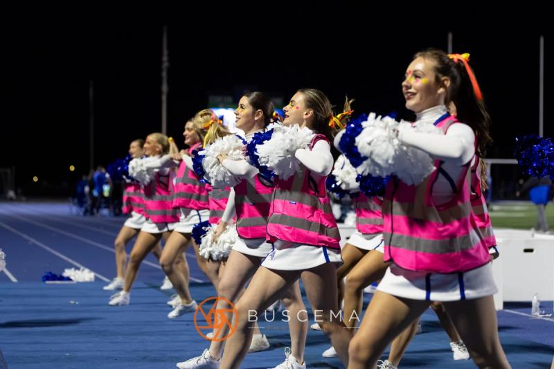 Coeur d'Alene cheerleaders in pink along the track during the Rigby game