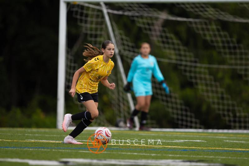 Sting 13-14G Academy player advancing on the Mt. Rainier goalkeeper