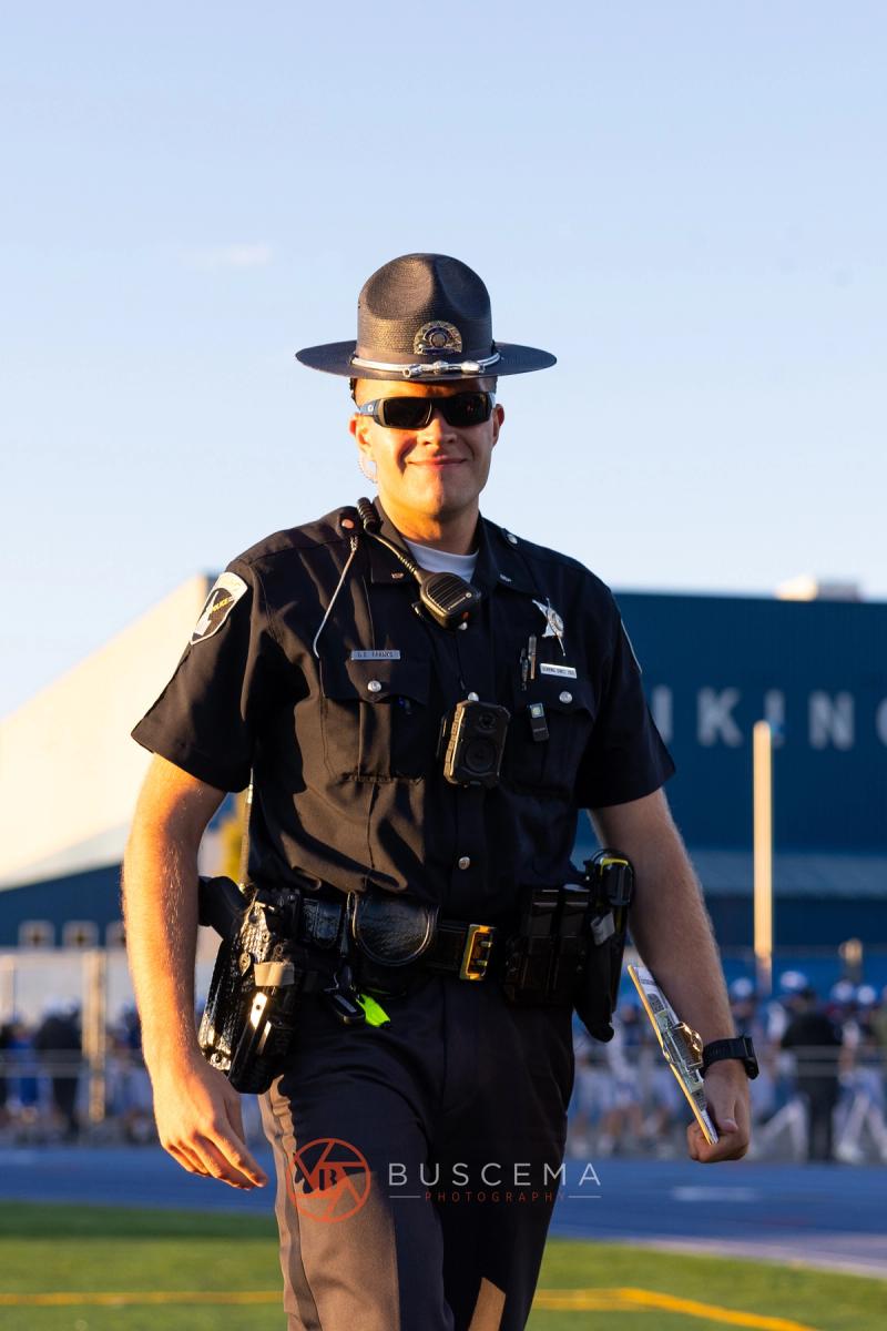 A police officer working the sideline at the Coeur d'Alene football home opener