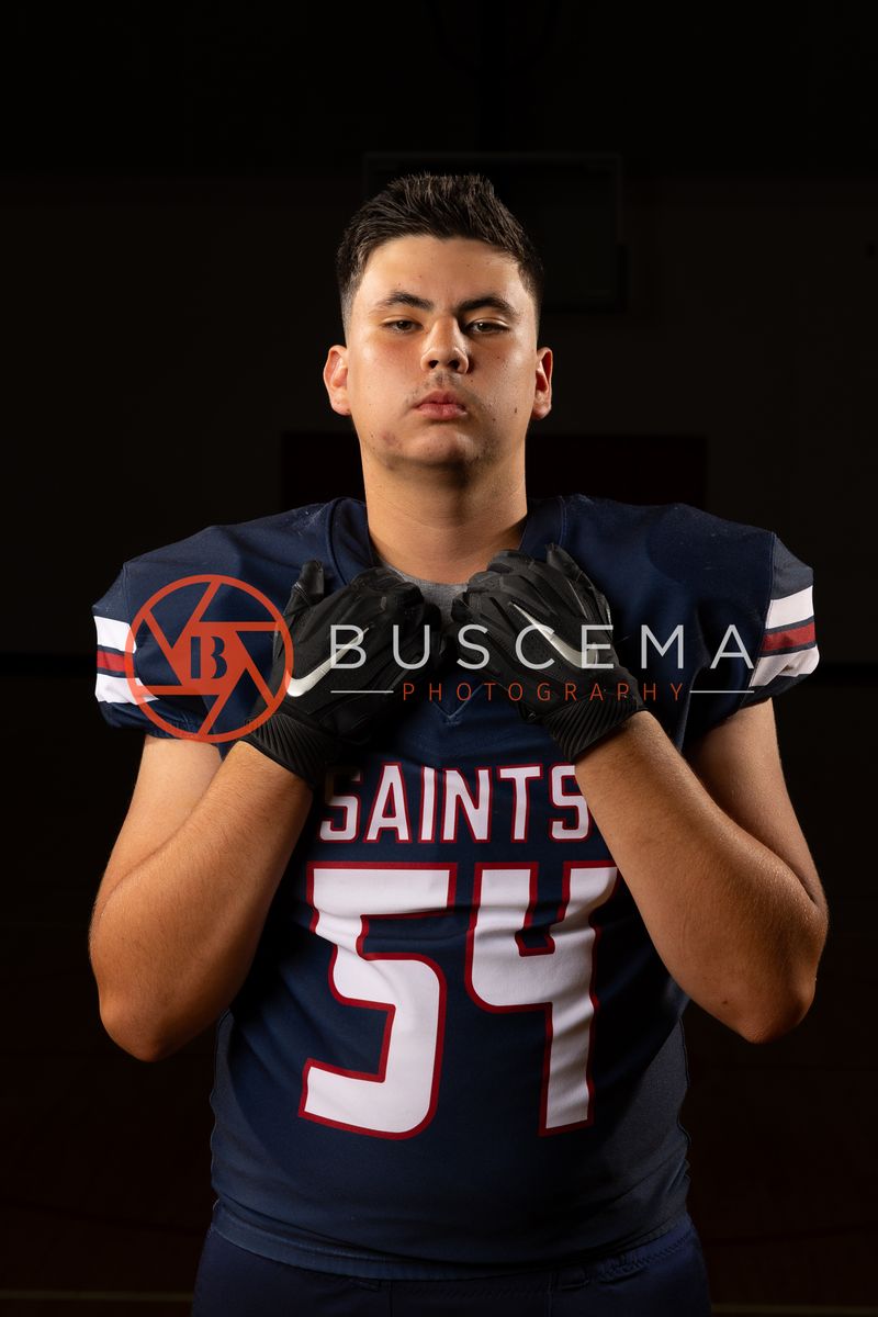 Coeur du Christ Academy football player in a number 54 Saints jersey