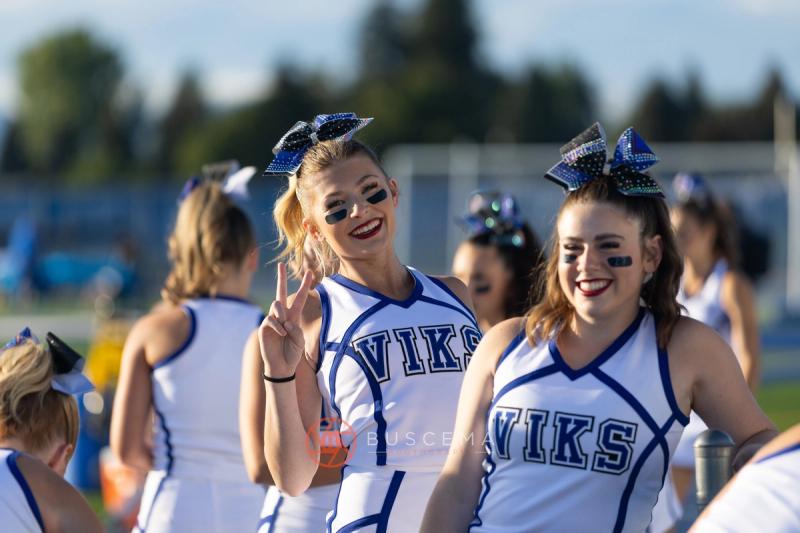 Coeur d'Alene cheerleaders in Viks uniforms on the sideline before kickoff