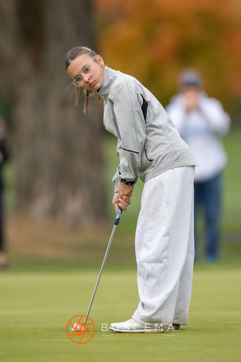 Girls golfer watching her putt roll at the 6A state golf championships at Avondale Golf Club