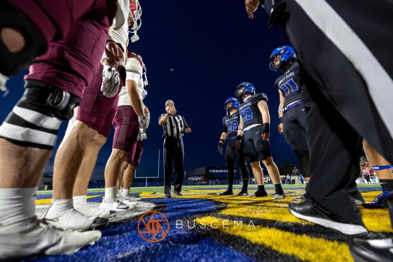Captains and officials at midfield for the coin toss before Coeur d'Alene and Rigby