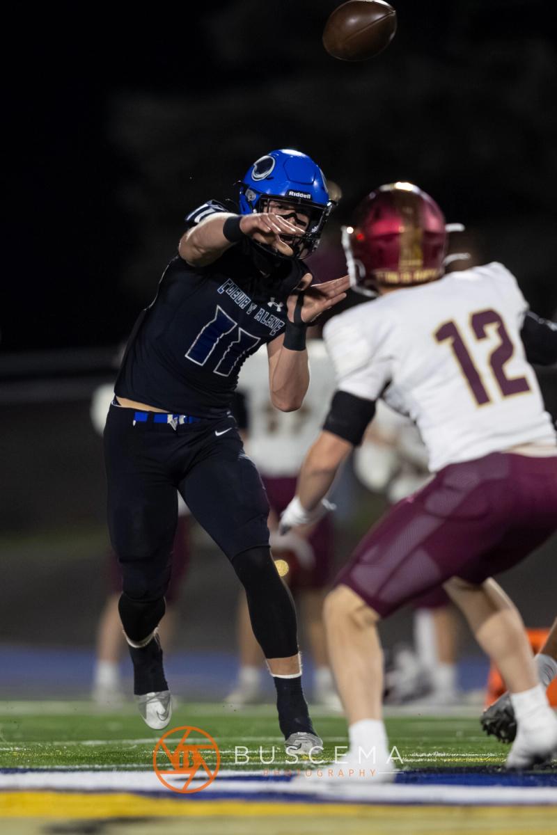 Coeur d'Alene quarterback throwing with a Rigby defender closing in
