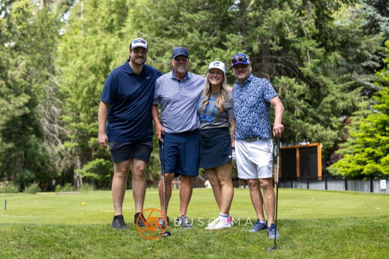 A foursome smiling together on the Avondale course