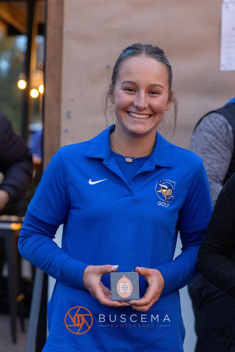 Coeur d'Alene girls golfer smiling with her state medal at the 6A state golf championships at Avondale Golf Club