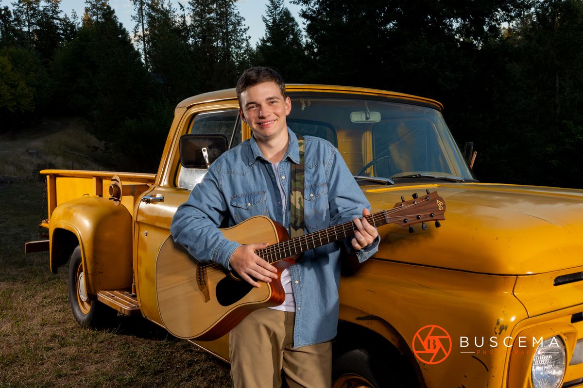 Senior playing guitar in front of a classic truck. Coeur d'Alene Senior Portraits. By Jason Buscema, Coeur d'Alene, Idaho Senior Photographer.