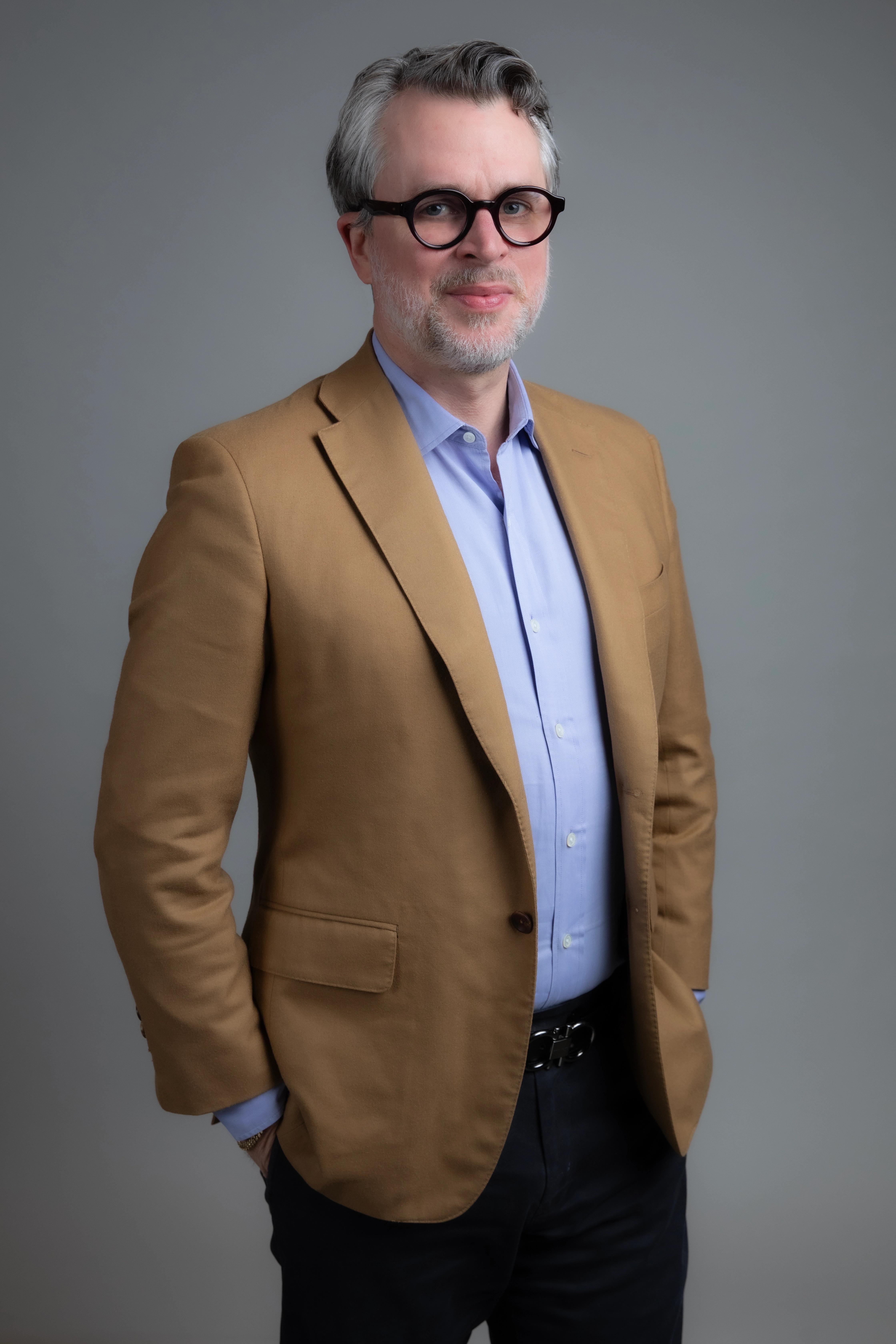 Portrait of Matthew Putman on a gray background