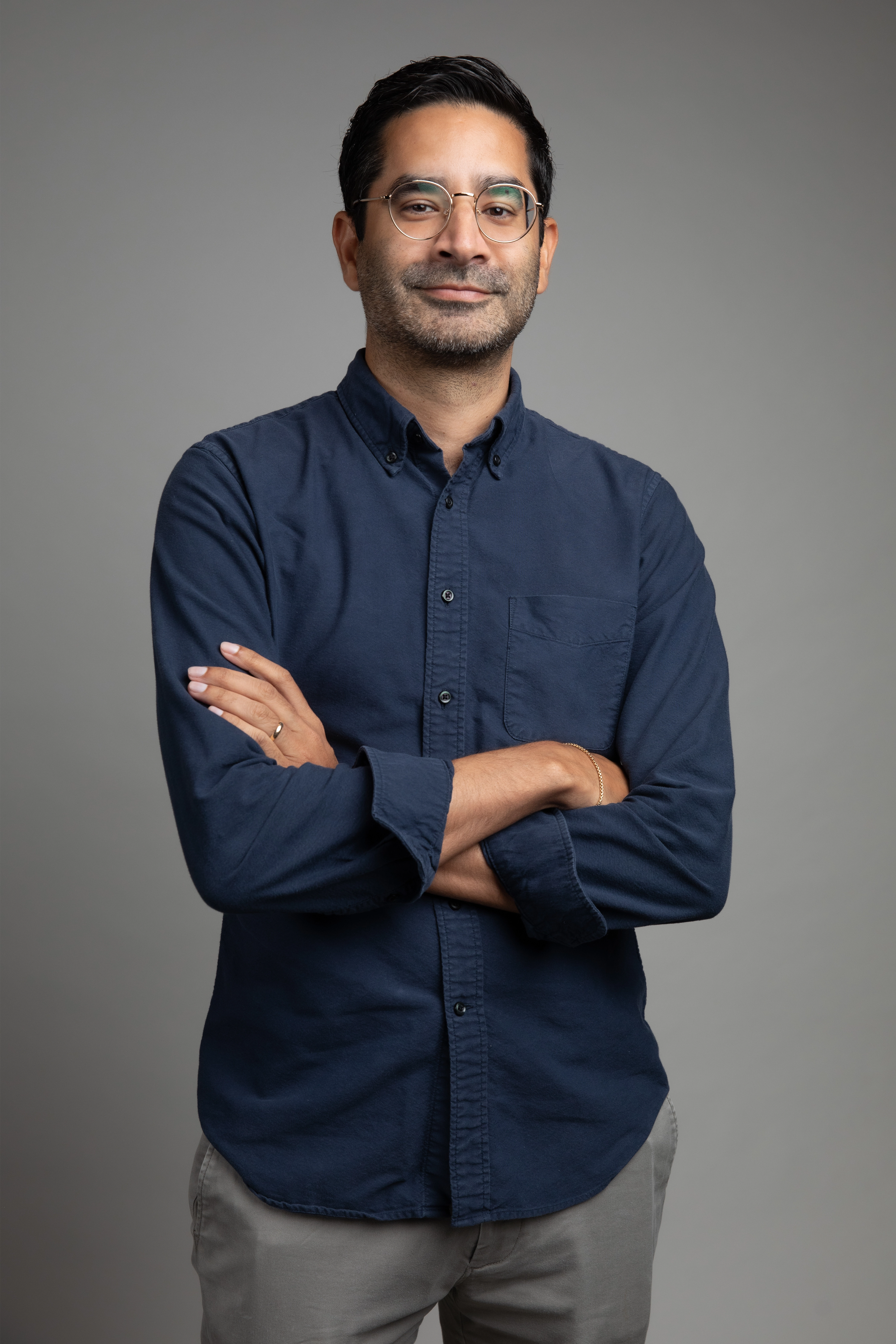 Portrait of Sanjay Raveendranath on a gray background