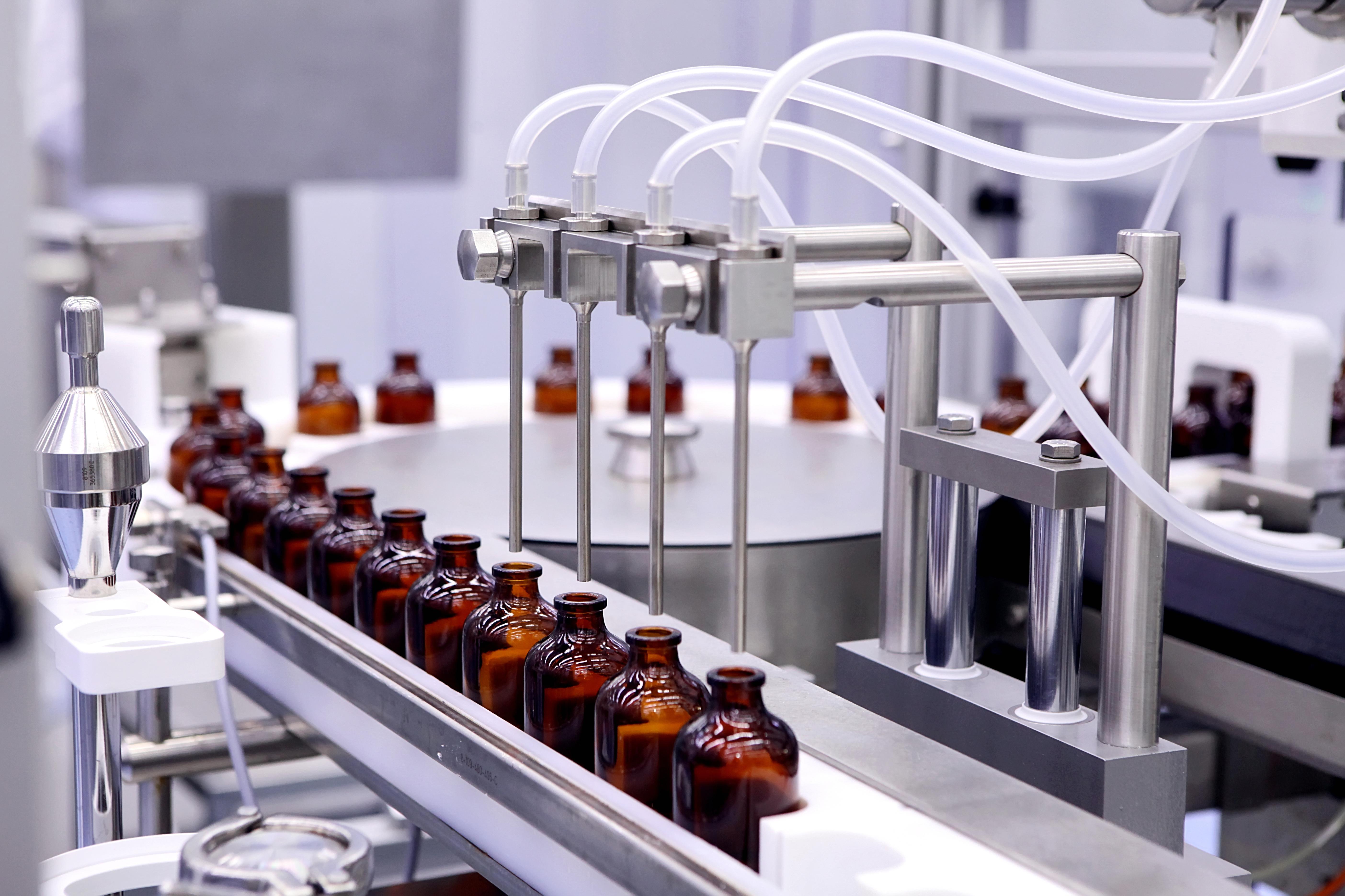 Medicine bottles being filled with an automated fluidics system