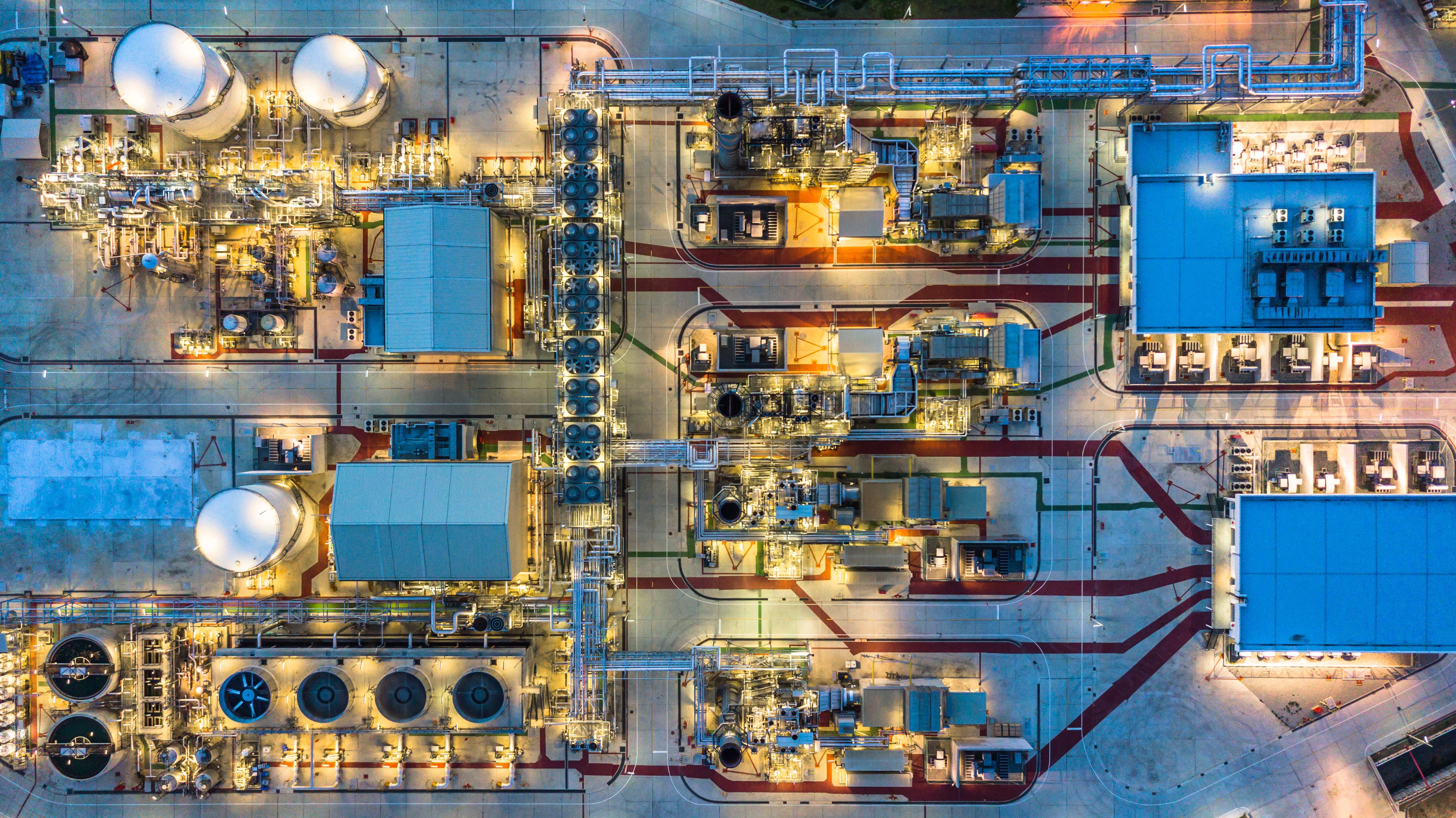 Birds eye view of chemical manufacturing plant with lights on at night