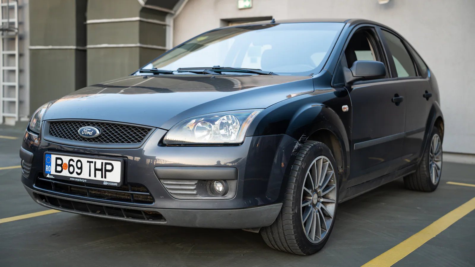 Grey Ford Focus hatchback photographed from the front in an urban Bucharest car park