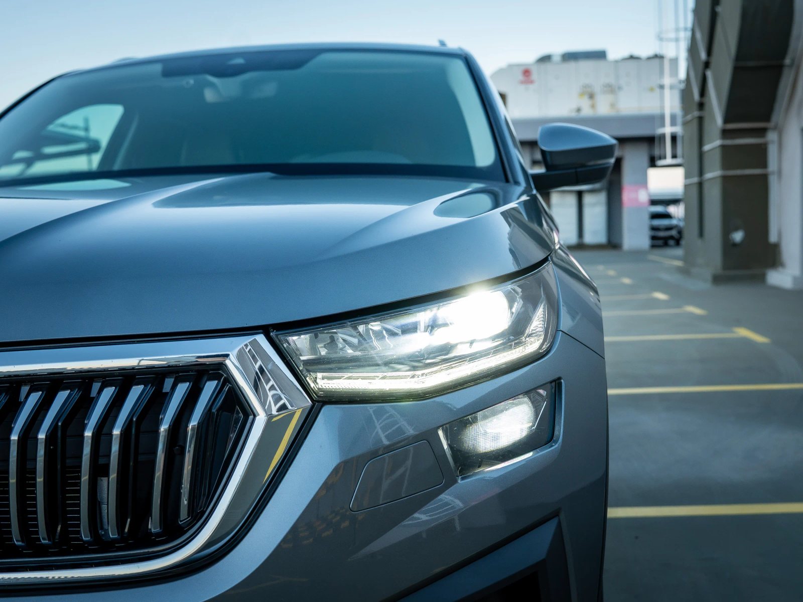 Škoda Kodiaq gri, farul din stânga surprins din apropiere.