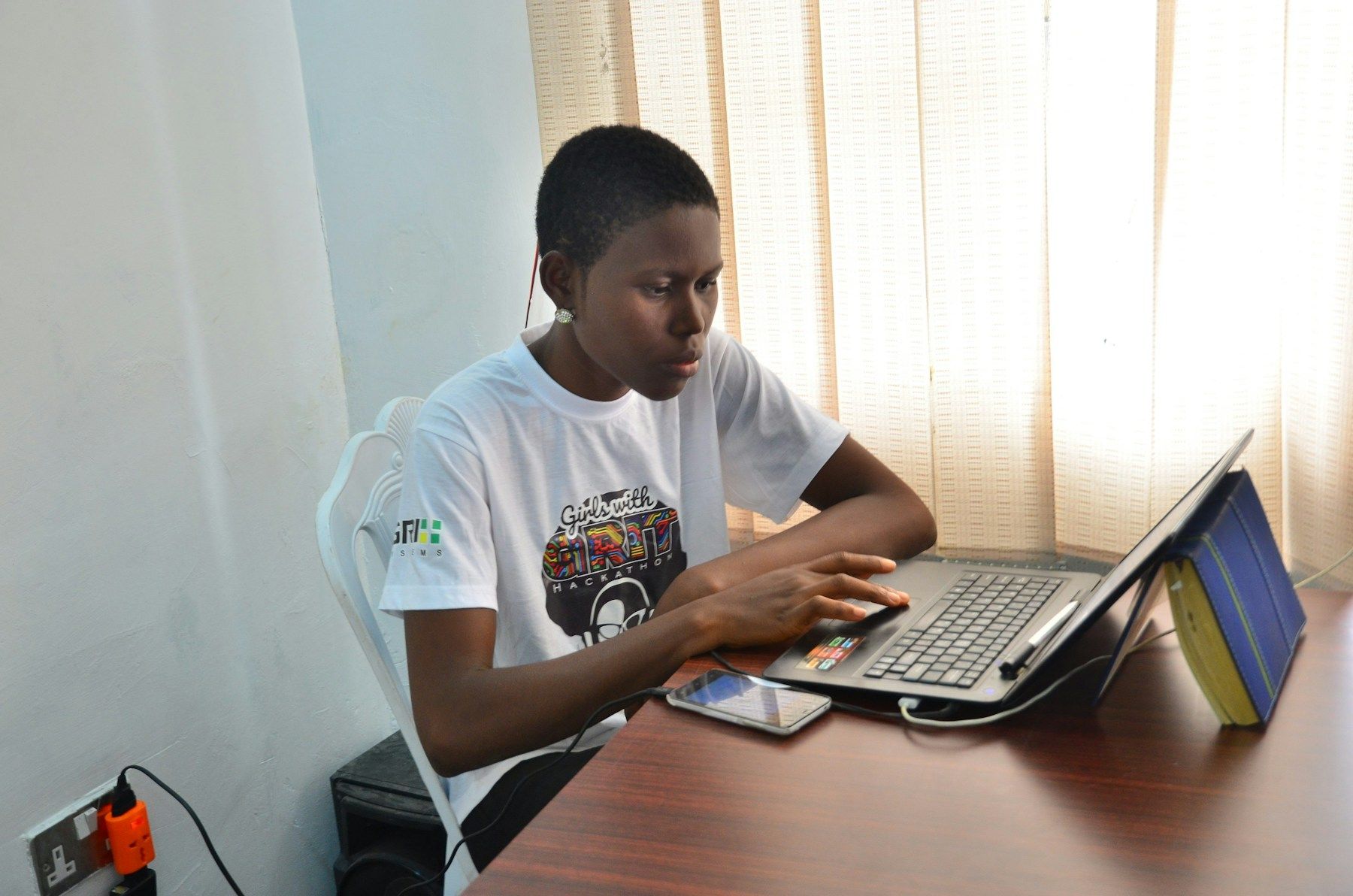 A young man registering online on a laptop