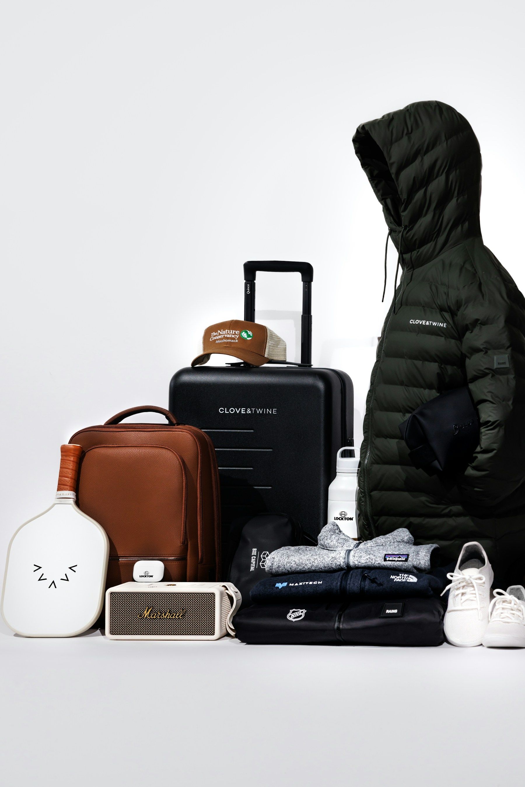 Travel essentials and clothing laid out for packing