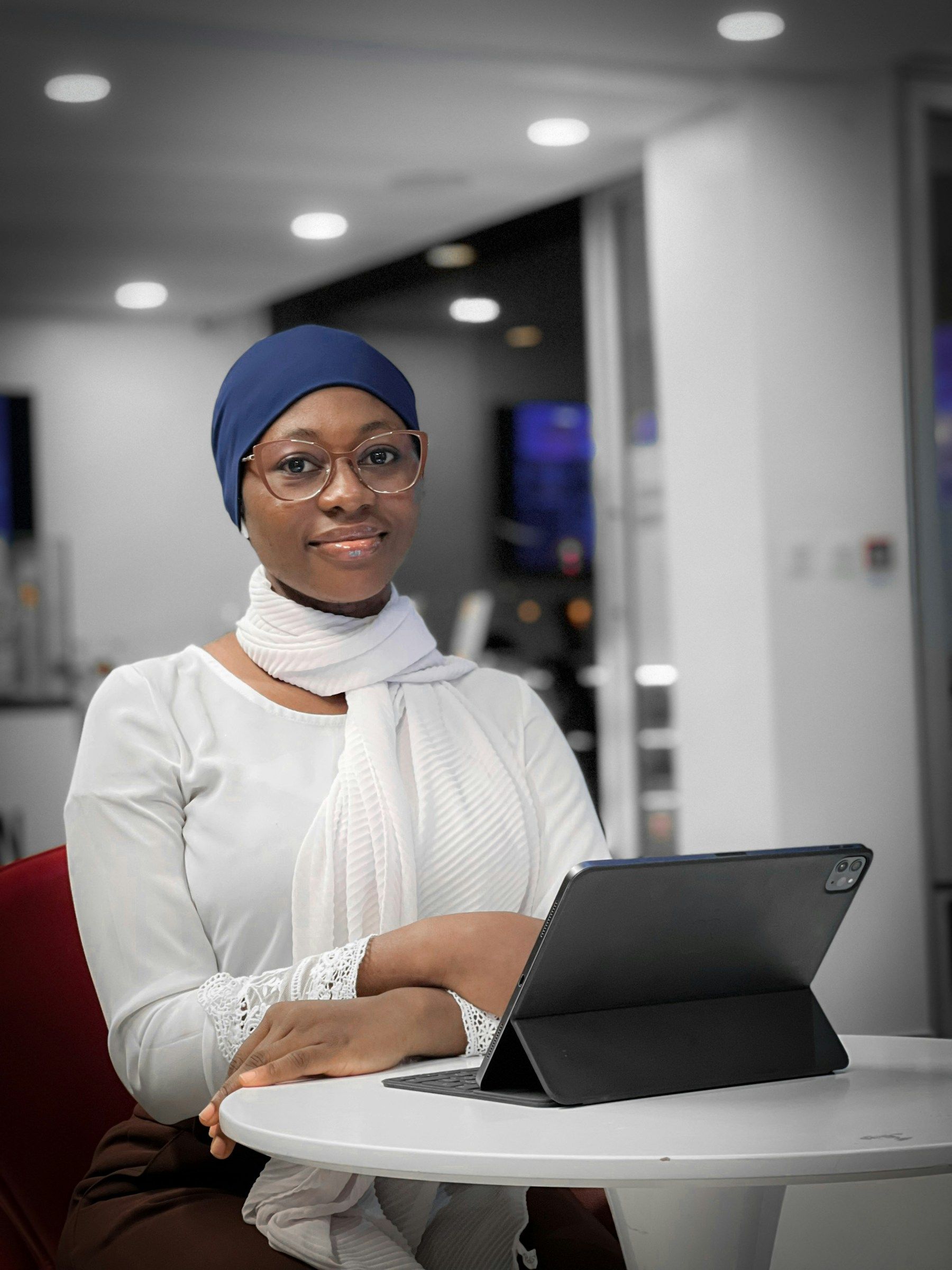 A young woman reviewing documents on a laptop