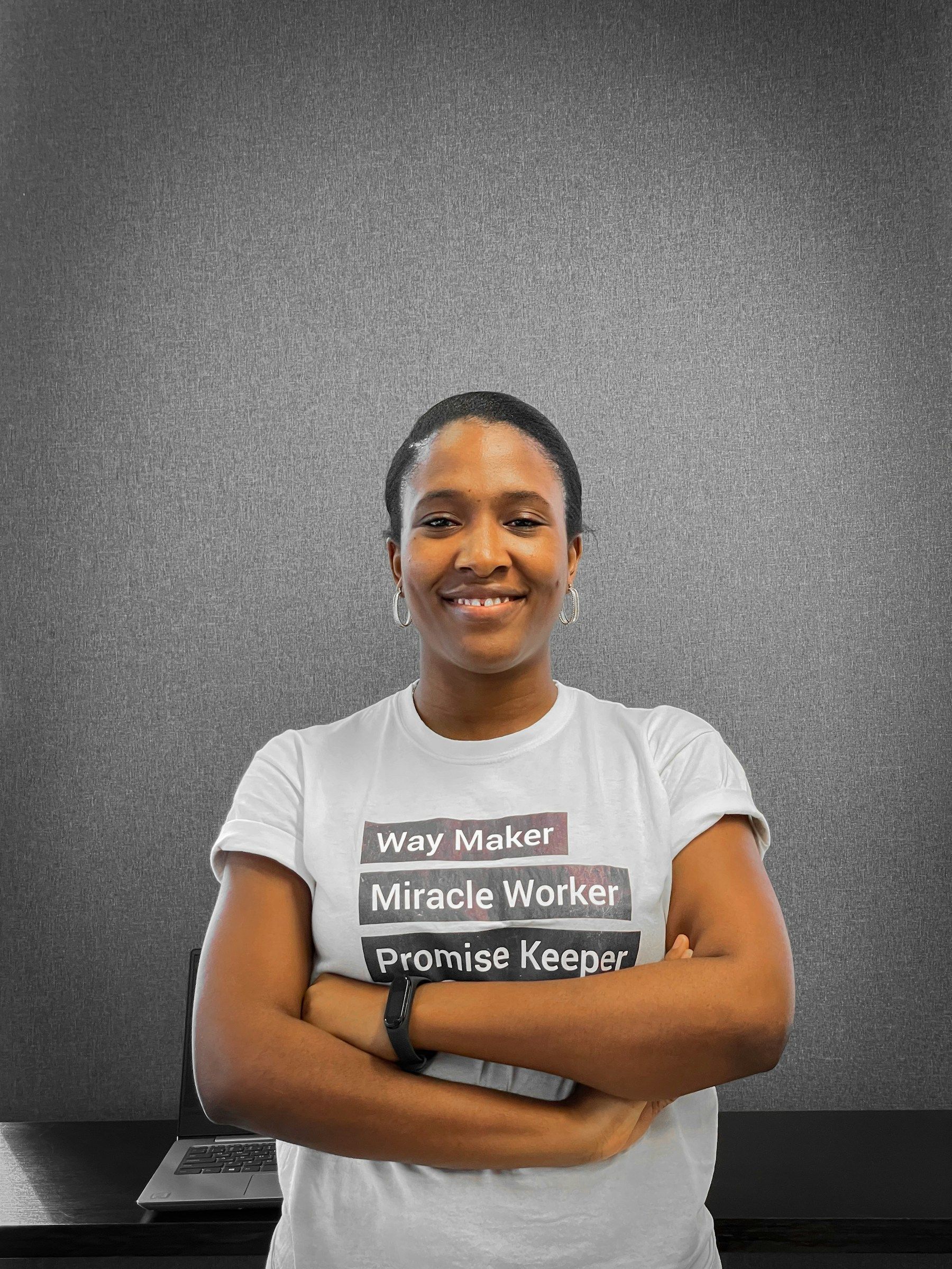 A confident young professional woman standing with arms crossed