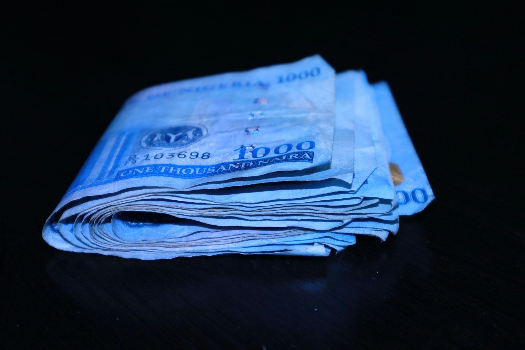Folded naira notes on a table
