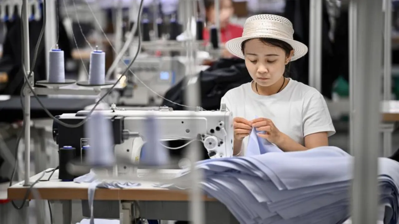 Un’operaia al lavoro in uno stabilimento ERKE. Minning, 11 settembre 2026. Foto Xinhua/Yang Zhisen