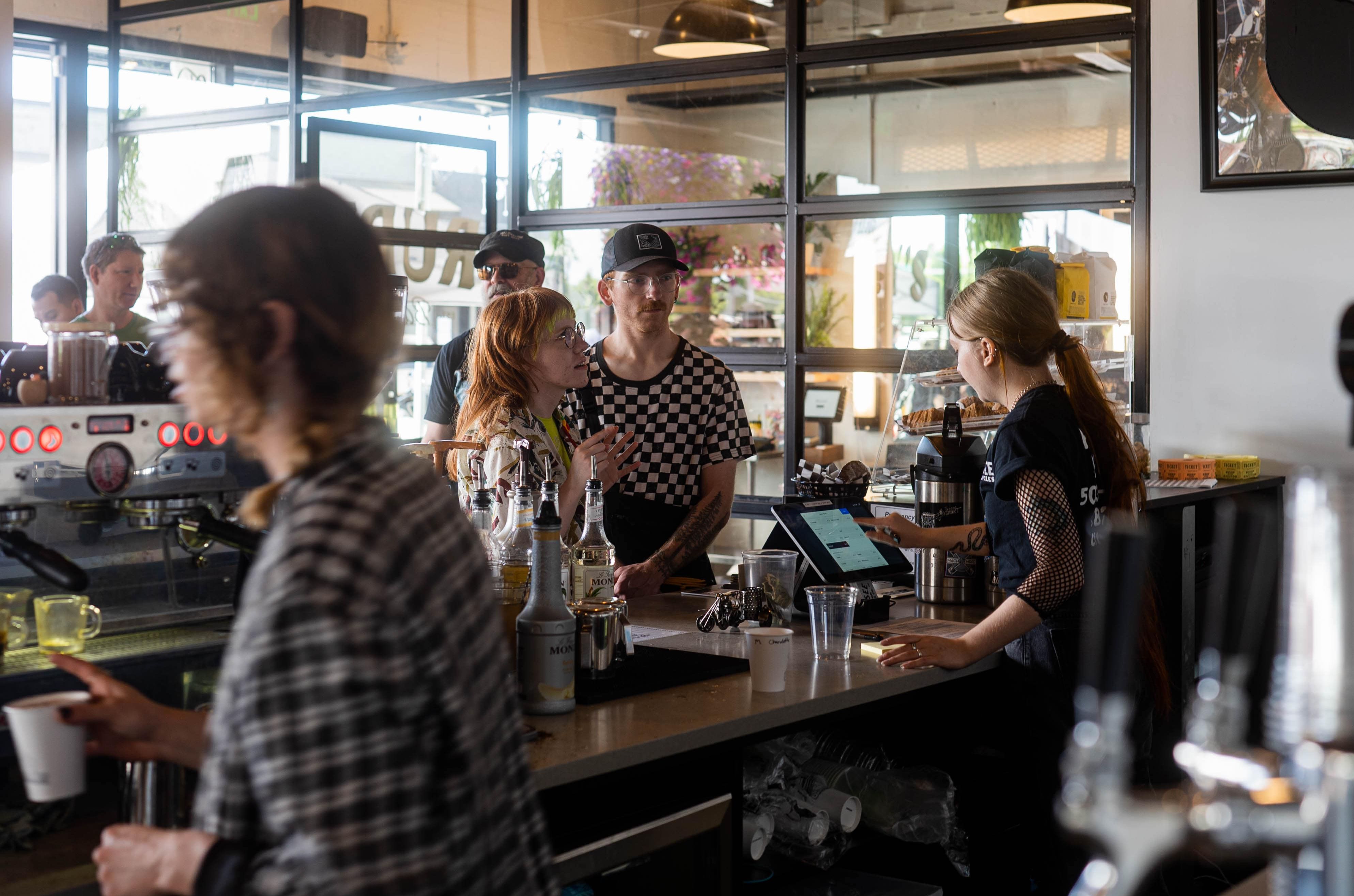 People ordering coffees at the See See's / Rudy's barbershop grand opening in Beaverton, OR.