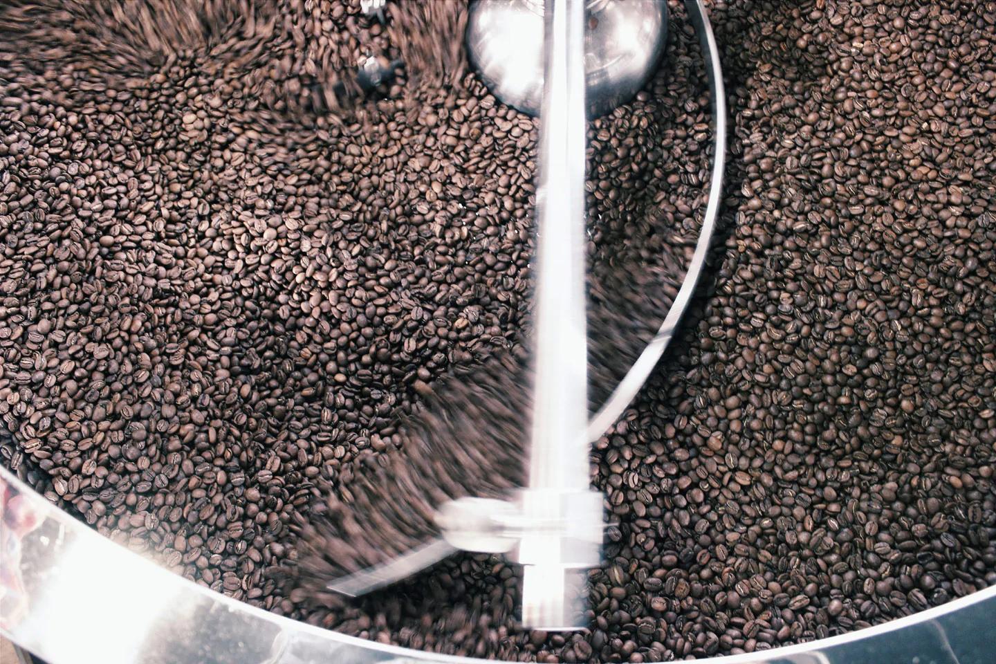A bunch of coffee beans being roasted. 