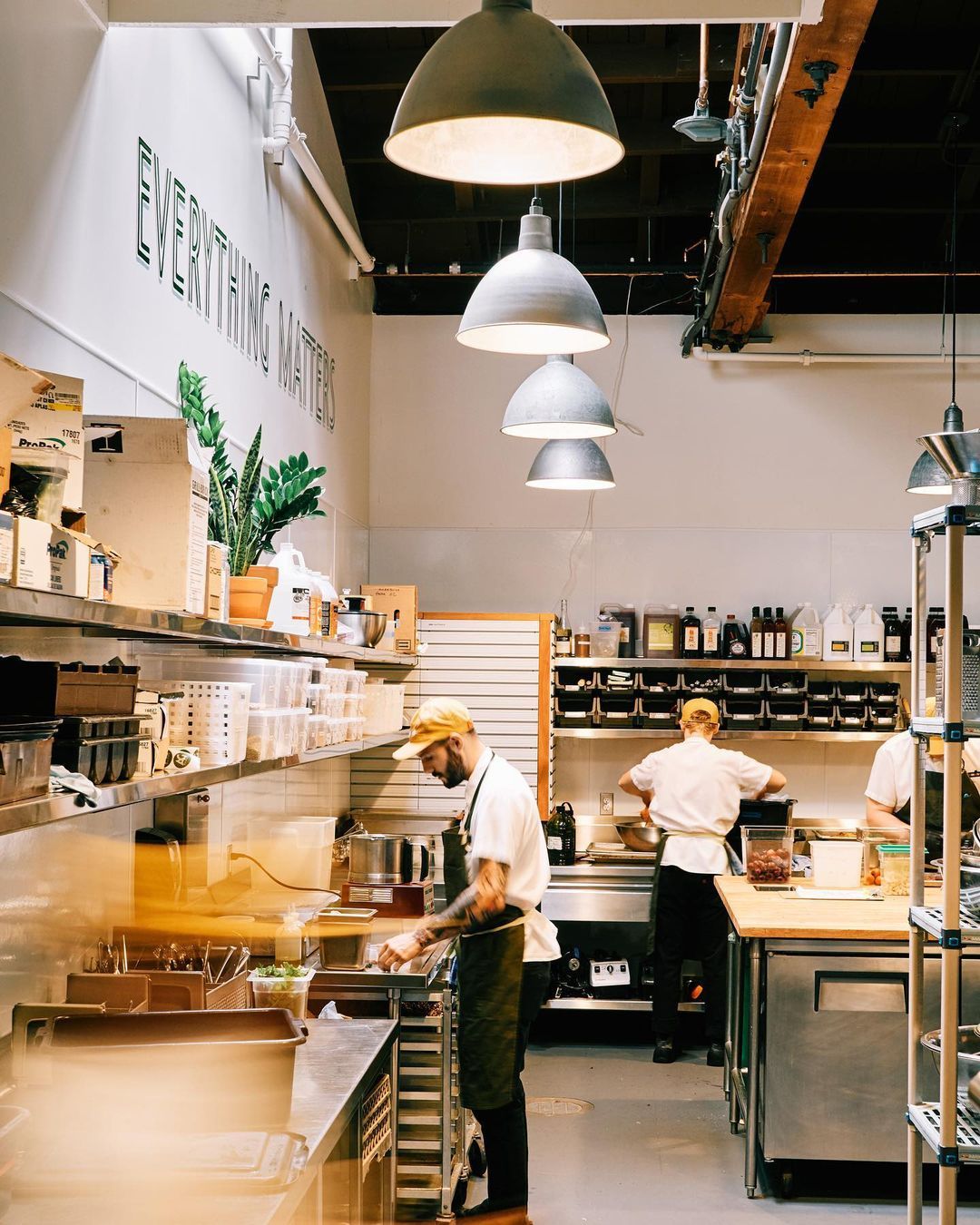 Kitchen staff at Ava Gene's working on preparing dinner dishes.