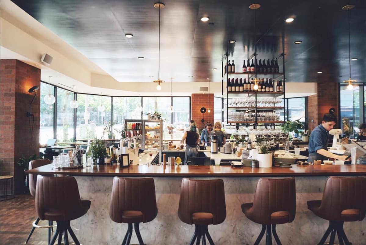 A row of swivel bar chairs in front of a countertop
