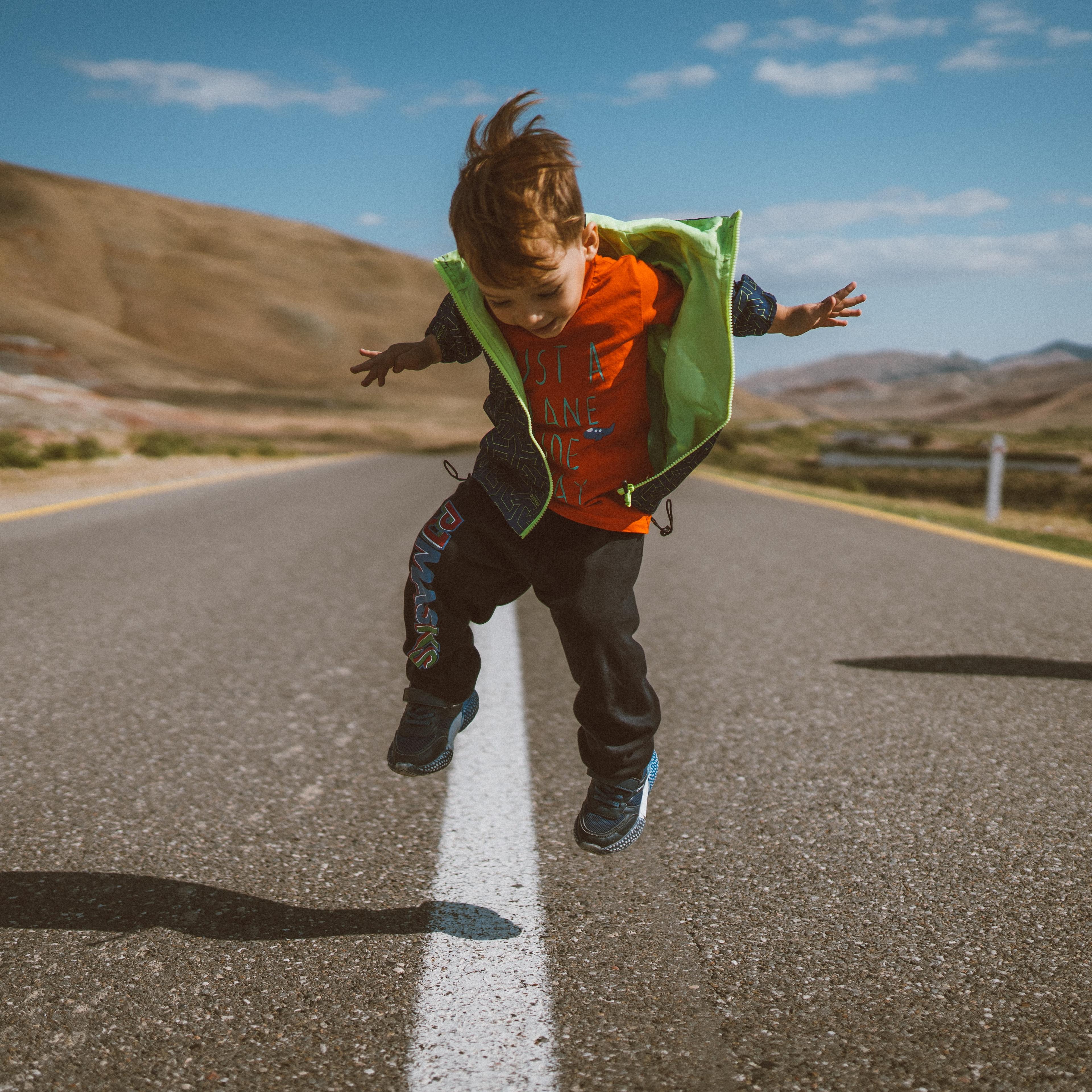 Kid jumping over a streetline