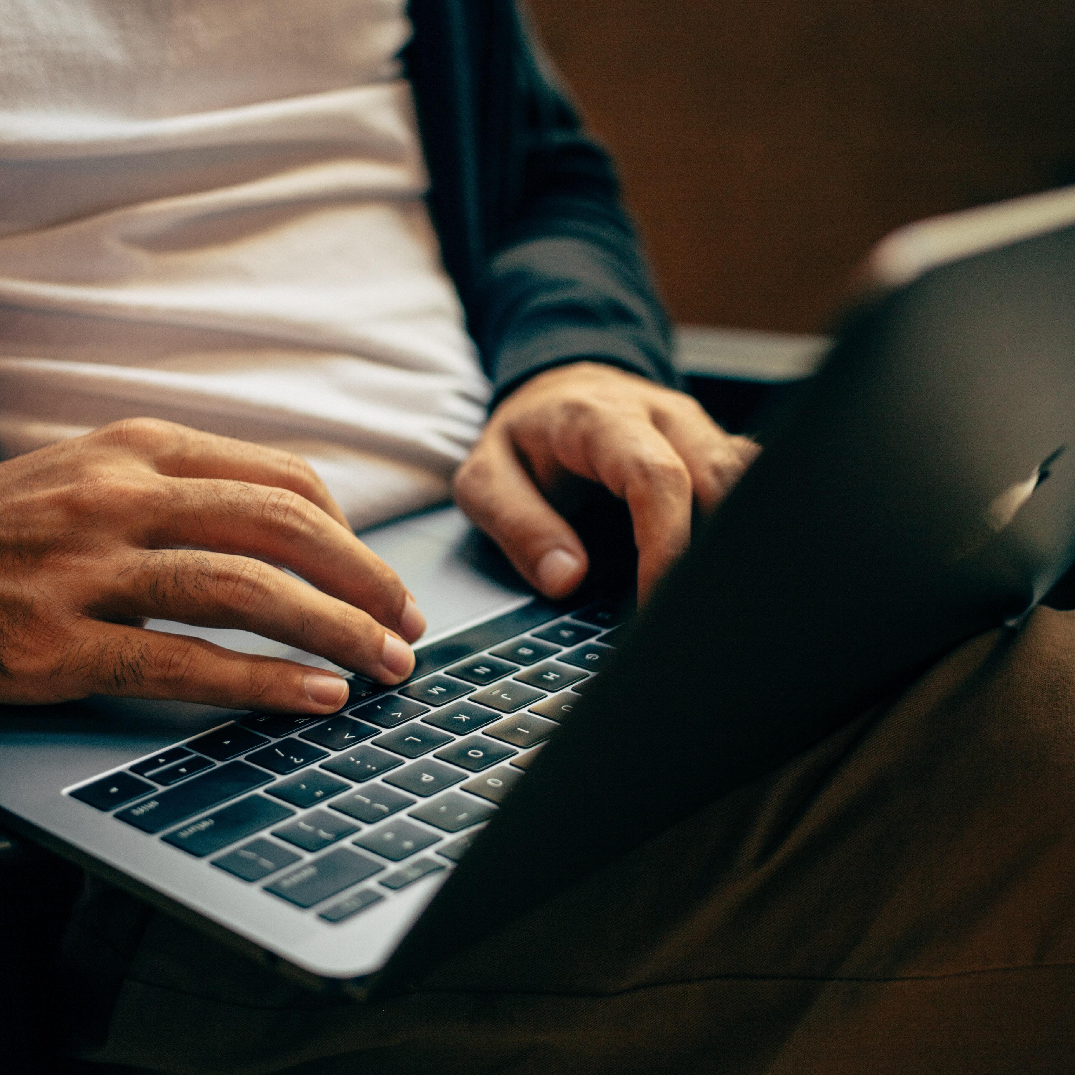 A person writing on his computer
