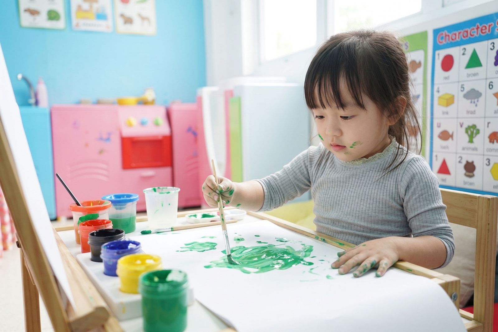 A child painting at an easel