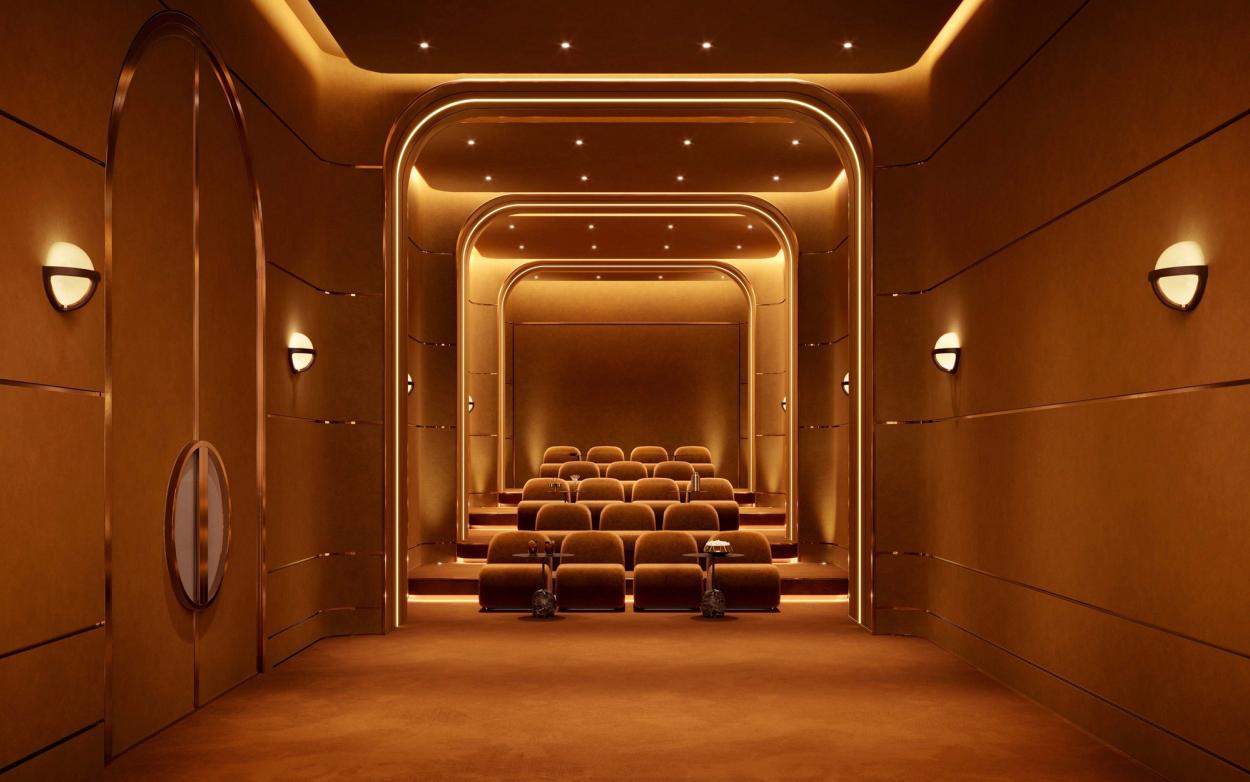 Intimate screening room for private screenings with plush modernist loungers and a sculptural backlit onyx cocktail bar.