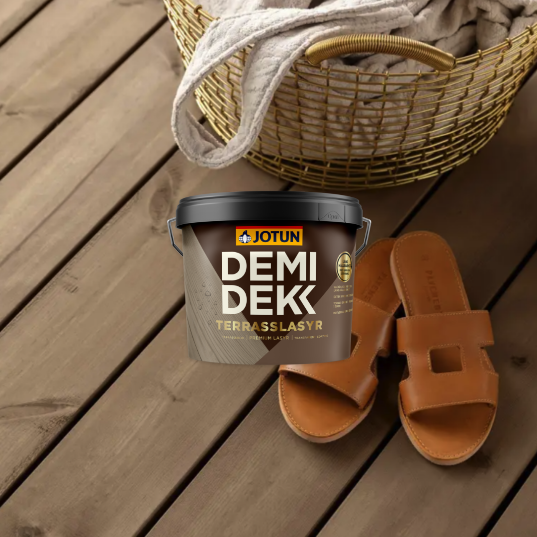 A bucket of Jotun Demidekk Terrasslasyr deck stain and brown sandals on a wooden deck with a golden basket in the background.