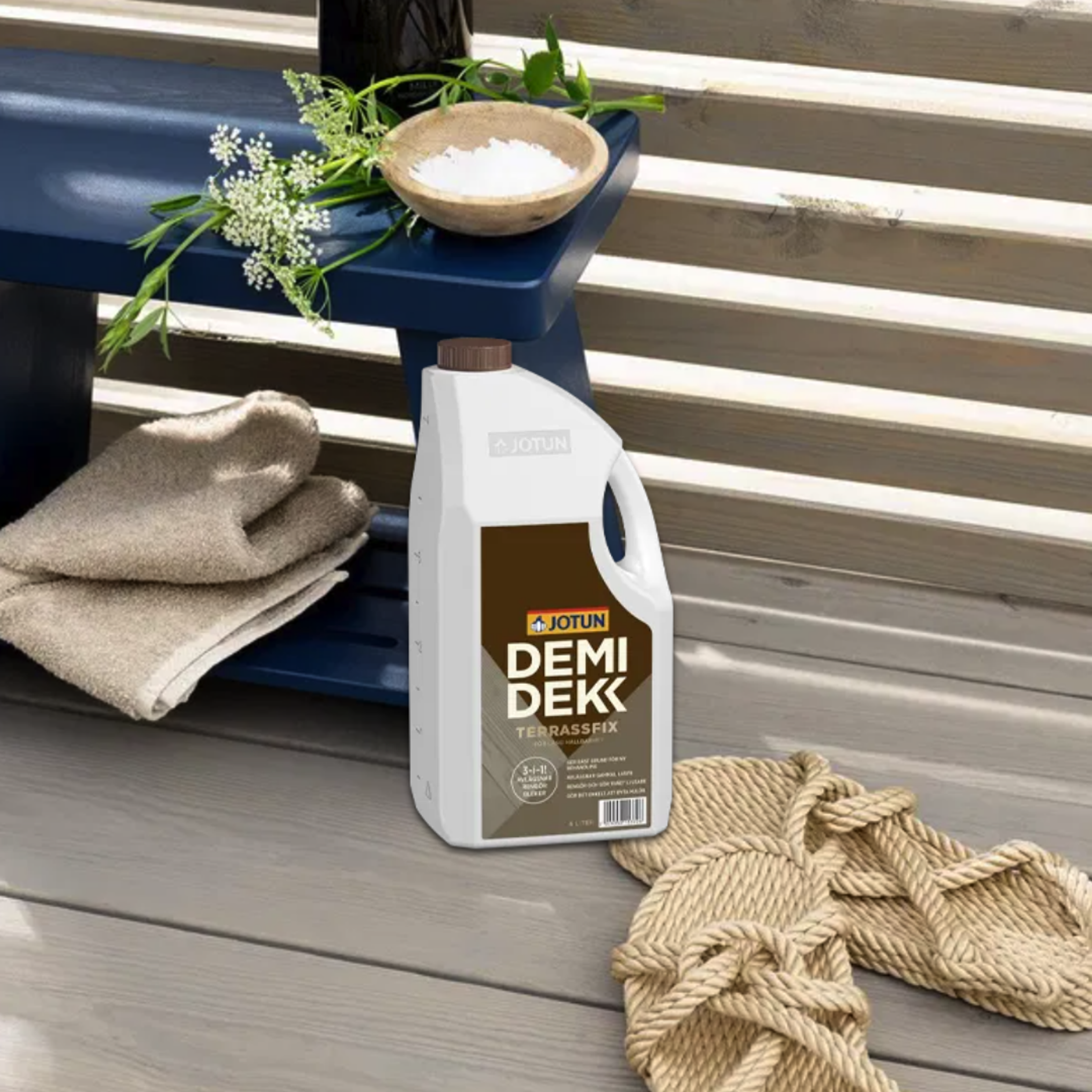 A bottle of Jotun Demidekk Terrassfix on a wooden deck.