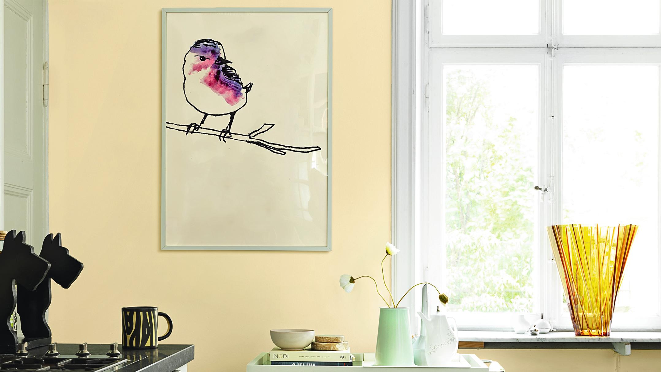 A light yellow room with a framed watercolor bird art, bright window, and decorative vases.