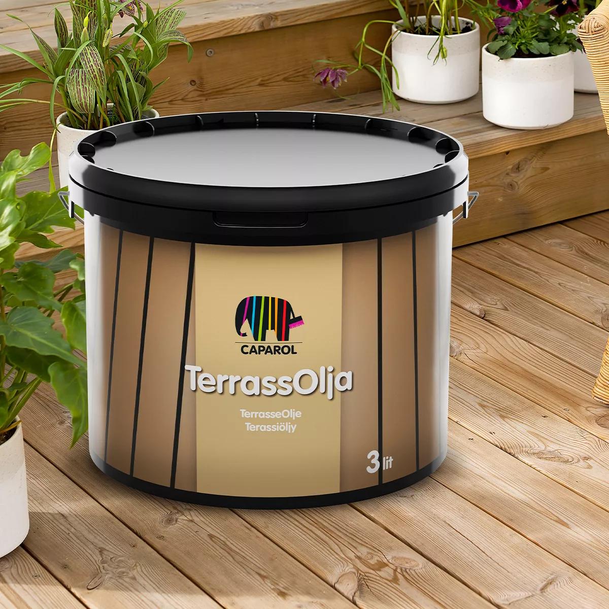 A bucket of Caparol TerrassOlja (deck oil) on a wooden deck.