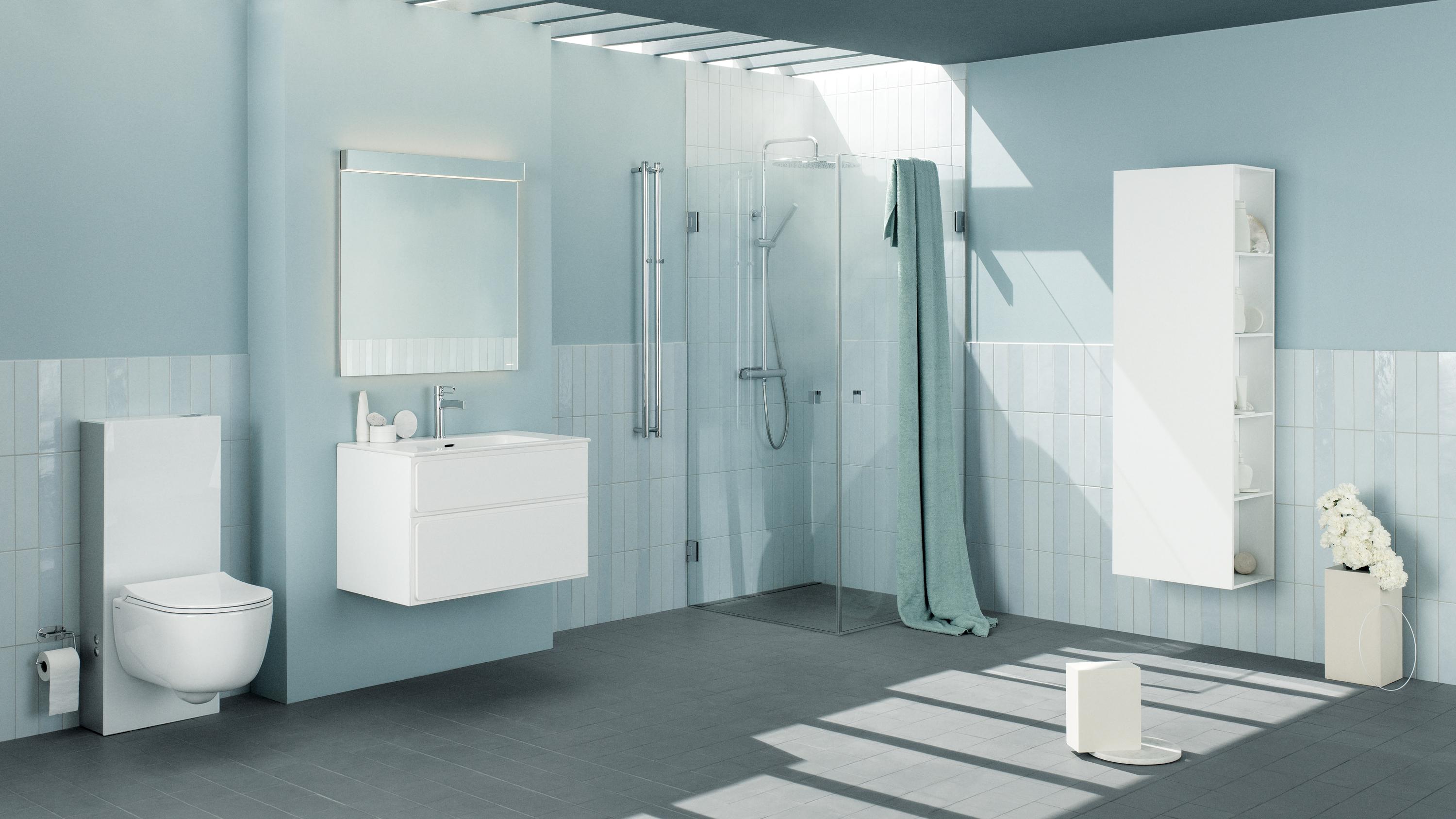 A modern light blue bathroom with white wall-mounted toilet, vanity, glass shower, and storage cabinet.