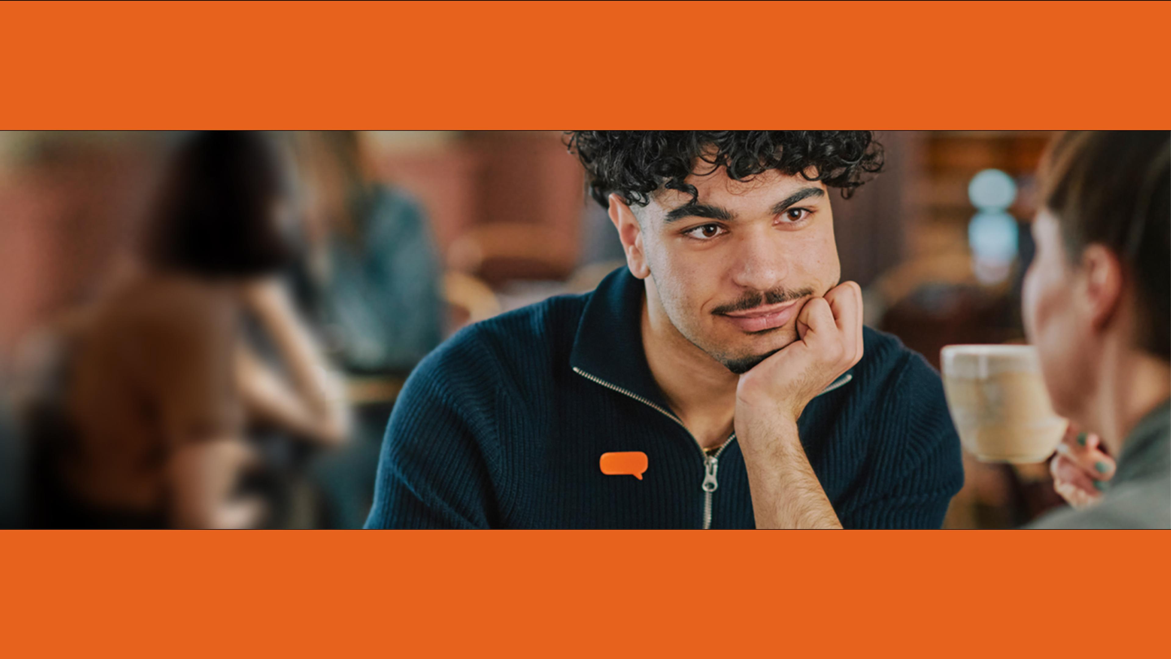 A man with curly hair and an orange speech bubble pin on his shirt looks thoughtfully at a woman holding a mug in a cafe.​​​​‌﻿‍﻿​‍​‍‌‍﻿﻿‌﻿​‍‌‍‍‌‌‍‌﻿‌‍‍‌‌‍﻿‍​‍​‍​﻿‍‍​‍​‍‌﻿​﻿‌‍​‌‌‍﻿‍‌‍‍‌‌﻿‌​‌﻿‍‌​‍﻿‍‌‍‍‌‌‍﻿﻿​‍​‍​‍﻿​​‍​‍‌‍‍​‌﻿​‍‌‍‌‌‌‍‌‍​‍​‍​﻿‍‍​‍​‍‌‍‍​‌﻿‌​‌﻿‌​‌﻿​​‌﻿​﻿​﻿‍‍​‍﻿﻿​‍﻿﻿‌﻿‌﻿‌﻿‌﻿‌﻿‌﻿​‍﻿‍‌‍​﻿‌‍﻿﻿‌‍﻿​‌‍﻿﻿‌﻿​‍‌‍​‌‌‍﻿‌‌‍​‌​‍﻿‍‌﻿​﻿‌‍‌‌​‍﻿﻿‌﻿​﻿‌﻿‌​‌﻿‌‌‌‍‌​‌‍‍‌‌‍﻿﻿​‍﻿﻿‌‍‍‌‌‍﻿‍‌﻿‌​‌‍‌‌‌‍﻿‍‌﻿‌​​‍﻿﻿‌‍‌‌‌‍‌​‌‍‍‌‌﻿‌​​‍﻿﻿‌‍﻿‌‌‍﻿﻿‌‍‌​‌‍‌‌​﻿﻿‌‌﻿​​‌﻿​‍‌‍‌‌‌﻿​﻿‌‍‌‌‌‍﻿‍‌﻿‌​‌‍​‌‌﻿‌​‌‍‍‌‌‍﻿﻿‌‍﻿‍​﻿‍﻿‌‍‍‌‌‍‌​​﻿﻿‌​﻿​‌‌‍​‍‌‍‌‍‌‍‌​​﻿‍​‌‍‌​​﻿‍‌​﻿‍‌​‍﻿‌‌‍‌‌‌‍‌​​﻿​‌‌‍‌‌​‍﻿‌​﻿‌​​﻿​​​﻿‌​‌‍‌‍​‍﻿‌‌‍​‍‌‍​‌​﻿​‌​﻿​﻿​‍﻿‌‌‍‌‌‌‍‌‌​﻿‌​‌‍‌‌​﻿‌‌‌‍‌‌‌‍​‍​﻿‍​​﻿​​​﻿‍‌‌‍​﻿​﻿​‌​﻿‍﻿‌﻿‌​‌﻿‍‌‌﻿​​‌‍‌‌​﻿﻿‌‌‍​﻿‌‍﻿﻿‌‍﻿‍‌﻿‌​‌‍‌‌‌‍﻿‍‌﻿‌​‌‌​​‌‍​‌‌‍‌﻿‌‍‌‌​﻿‍﻿‌﻿​​‌‍​‌‌﻿‌​‌‍‍​​﻿﻿‌‌‍​﻿‌‍﻿﻿‌‍﻿‍‌﻿‌​‌‍‌‌‌‍﻿‍‌﻿‌​‌​​‍‌‍﻿​‌‍﻿﻿‌‍​﻿‌‍‍﻿‌﻿​﻿​‍‌‌​﻿‌‌‌​​‍‌‌﻿﻿‌‍‍﻿‌‍‌‌‌﻿‍‌​‍‌‌​﻿​﻿‌​‌​​‍‌‌​﻿​﻿‌​‌​​‍‌‌​﻿​‍​﻿​‍​﻿​‍‌‍​‌​﻿‌﻿‌‍​﻿​﻿‍​‌‍‌‌​﻿​﻿‌‍​﻿‌‍‌‌‌‍‌​‌‍​‍​﻿‌‌​‍‌‌​﻿​‍​﻿​‍​‍‌‌​﻿‌‌‌​‌​​‍﻿‍‌‍﻿‌‌‍‌‌‌‍‌​‌‍‍‌‌‍​‌​‍﻿‍‌‍‍‌‌‍﻿‌‌‍​‌‌‍‌﻿‌‍‌‌​‍﻿‍‌‍​‌‌‍﻿​‌﻿‌​‌‌‌​‌‍‌‌‌﻿‍​‌﻿‌​​﻿﻿﻿‌‍​‍‌‍​‌‌﻿​﻿‌‍‌‌‌‌‌‌‌﻿​‍‌‍﻿​​﻿﻿‌‌‍‍​‌﻿‌​‌﻿‌​‌﻿​​‌﻿​﻿​‍‌‌​﻿​﻿‌​​‌​‍‌‌​﻿​‍‌​‌‍​‍‌‌​﻿​‍‌​‌‍‌﻿‌﻿‌﻿‌﻿‌﻿‌﻿​‍﻿‍‌‍​﻿‌‍﻿﻿‌‍﻿​‌‍﻿﻿‌﻿​‍‌‍​‌‌‍﻿‌‌‍​‌​‍﻿‍‌﻿​﻿‌‍‌‌​‍‌‌​﻿​‍‌​‌‍‌﻿​﻿‌﻿‌​‌﻿‌‌‌‍‌​‌‍‍‌‌‍﻿﻿​‍‌‍‌‍‍‌‌‍‌​​﻿﻿‌​﻿​‌‌‍​‍‌‍‌‍‌‍‌​​﻿‍​‌‍‌​​﻿‍‌​﻿‍‌​‍﻿‌‌‍‌‌‌‍‌​​﻿​‌‌‍‌‌​‍﻿‌​﻿‌​​﻿​​​﻿‌​‌‍‌‍​‍﻿‌‌‍​‍‌‍​‌​﻿​‌​﻿​﻿​‍﻿‌‌‍‌‌‌‍‌‌​﻿‌​‌‍‌‌​﻿‌‌‌‍‌‌‌‍​‍​﻿‍​​﻿​​​﻿‍‌‌‍​﻿​﻿​‌​‍‌‍‌﻿‌​‌﻿‍‌‌﻿​​‌‍‌‌​﻿﻿‌‌‍​﻿‌‍﻿﻿‌‍﻿‍‌﻿‌​‌‍‌‌‌‍﻿‍‌﻿‌​‌‌​​‌‍​‌‌‍‌﻿‌‍‌‌​‍‌‍‌﻿​​‌‍​‌‌﻿‌​‌‍‍​​﻿﻿‌‌‍​﻿‌‍﻿﻿‌‍﻿‍‌﻿‌​‌‍‌‌‌‍﻿‍‌﻿‌​‌​​‍‌‍﻿​‌‍﻿﻿‌‍​﻿‌‍‍﻿‌﻿​﻿​‍‌‌​﻿‌‌‌​​‍‌‌﻿﻿‌‍‍﻿‌‍‌‌‌﻿‍‌​‍‌‌​﻿​﻿‌​‌​​‍‌‌​﻿​﻿‌​‌​​‍‌‌​﻿​‍​﻿​‍​﻿​‍‌‍​‌​﻿‌﻿‌‍​﻿​﻿‍​‌‍‌‌​﻿​﻿‌‍​﻿‌‍‌‌‌‍‌​‌‍​‍​﻿‌‌​‍‌‌​﻿​‍​﻿​‍​‍‌‌​﻿‌‌‌​‌​​‍﻿‍‌‍﻿‌‌‍‌‌‌‍‌​‌‍‍‌‌‍​‌​‍﻿‍‌‍‍‌‌‍﻿‌‌‍​‌‌‍‌﻿‌‍‌‌​‍﻿‍‌‍​‌‌‍﻿​‌﻿‌​‌‌‌​‌‍‌‌‌﻿‍​‌﻿‌​​‍‌‍‌﻿​​‌‍‌‌‌﻿​‍‌﻿​﻿‌﻿​​‌‍‌‌‌‍​﻿‌﻿‌​‌‍‍‌‌﻿‌‍‌‍‌‌​﻿﻿‌‌﻿​​‌﻿‌‌‌‍​‍‌‍﻿​‌‍‍‌‌﻿​﻿‌‍‍​‌‍‌‌‌‍‌​​‍​‍‌﻿﻿‌