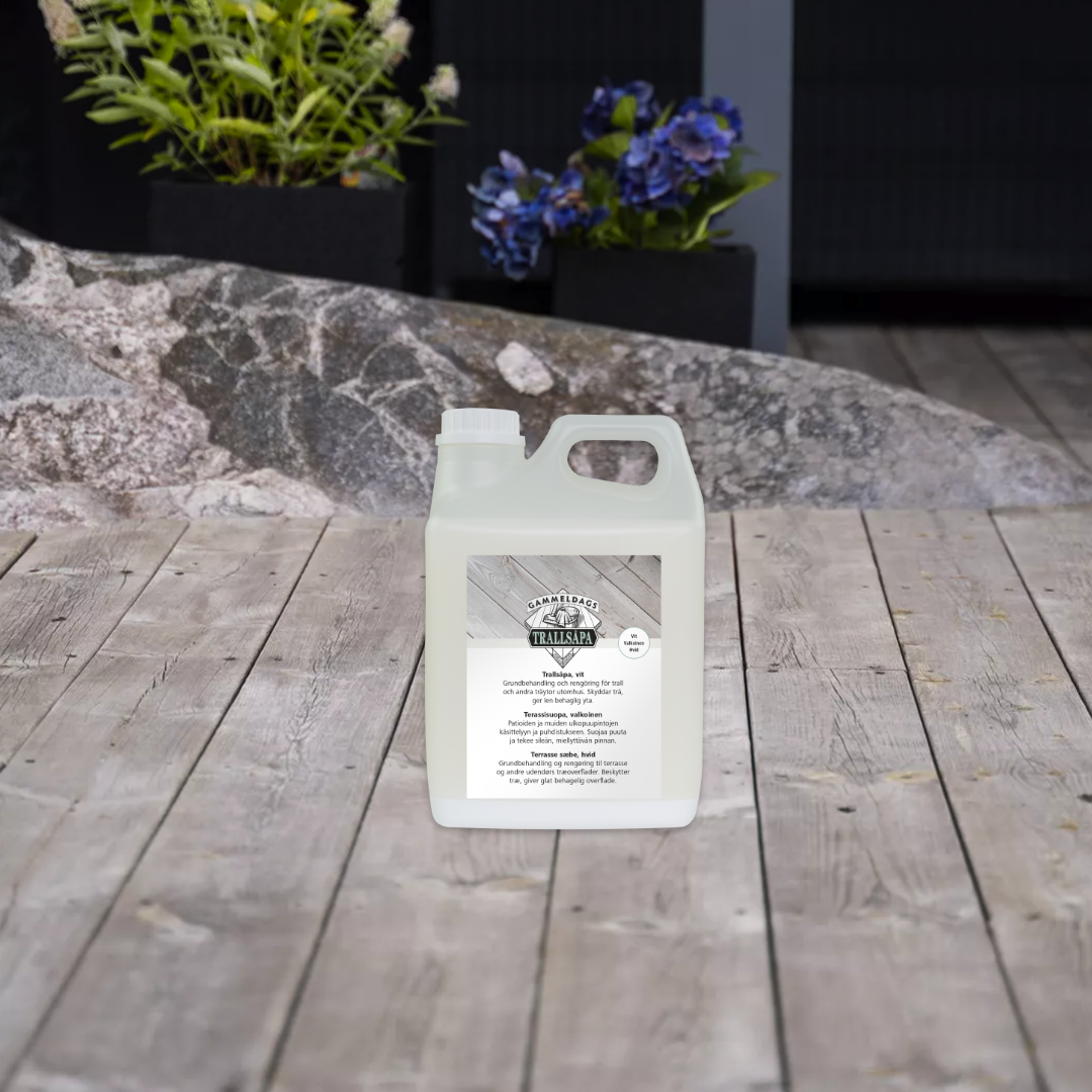 A translucent white jug of Trallsapa deck cleaner on a wooden deck.