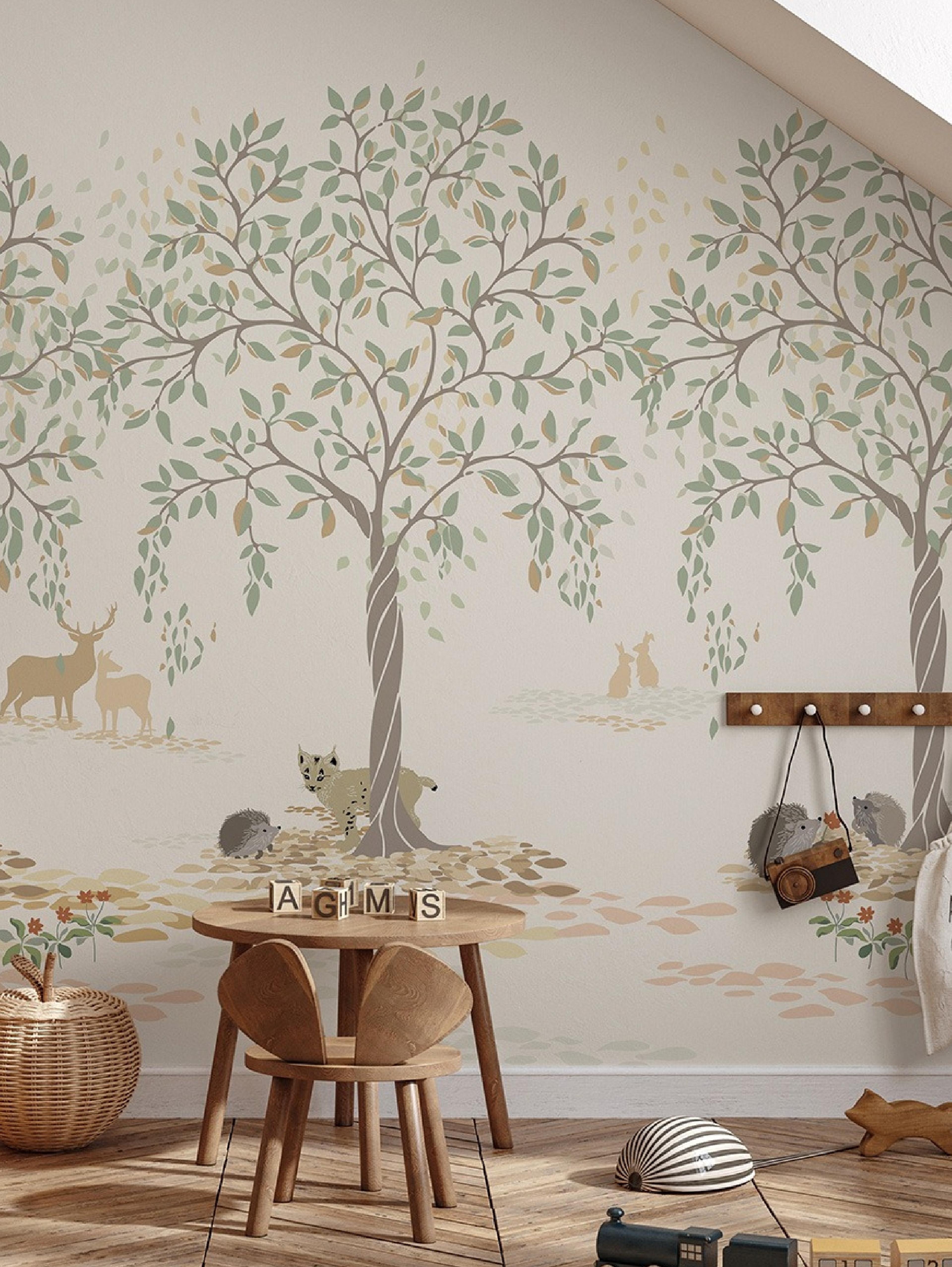 A child's room featuring a wall mural of stylized trees and woodland animals. A small wooden table and chair are in the foreground with toys.