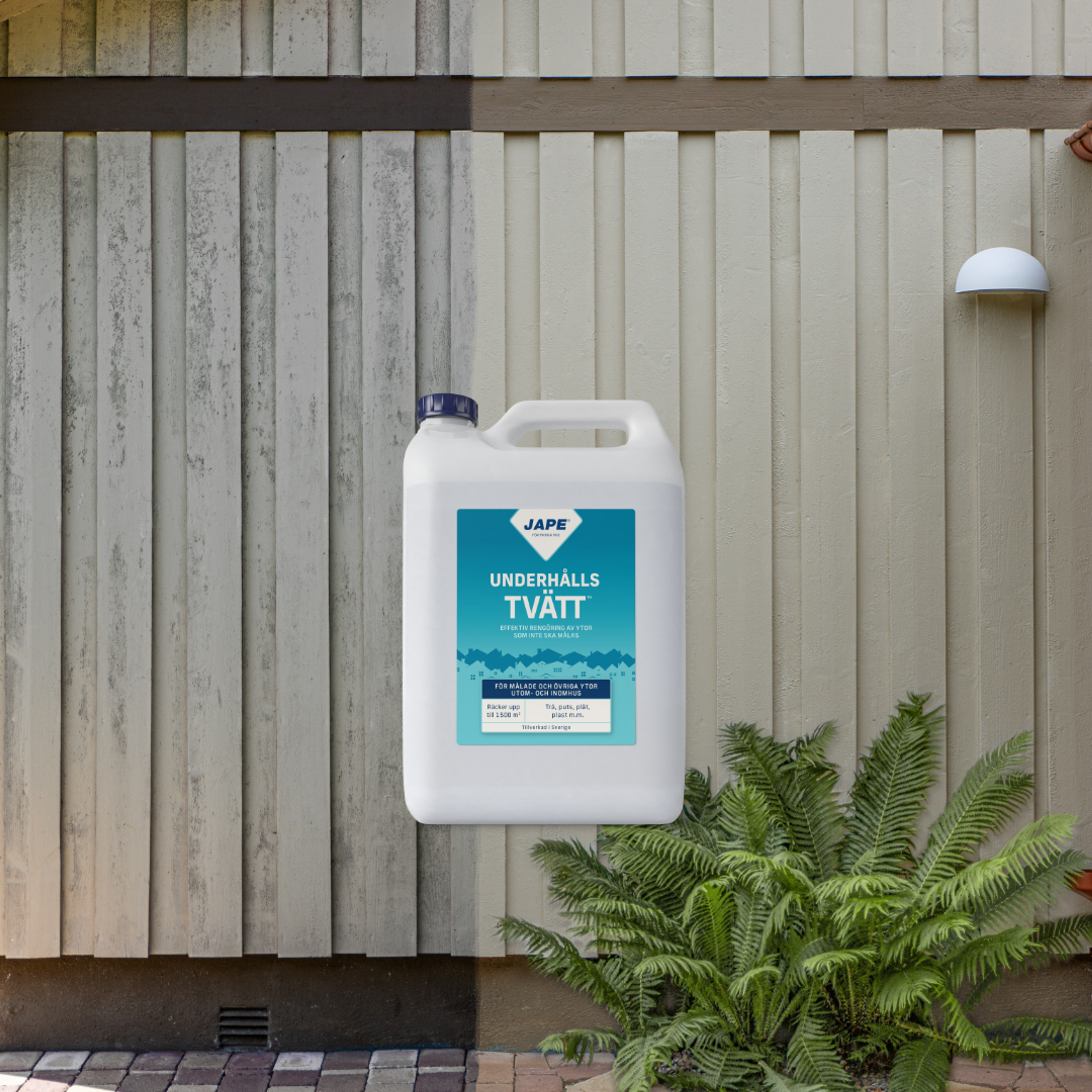 JAPE Maintenance Wash container positioned in front of a wooden wall, half of which is dirty and weathered, and the other half clean and light beige.