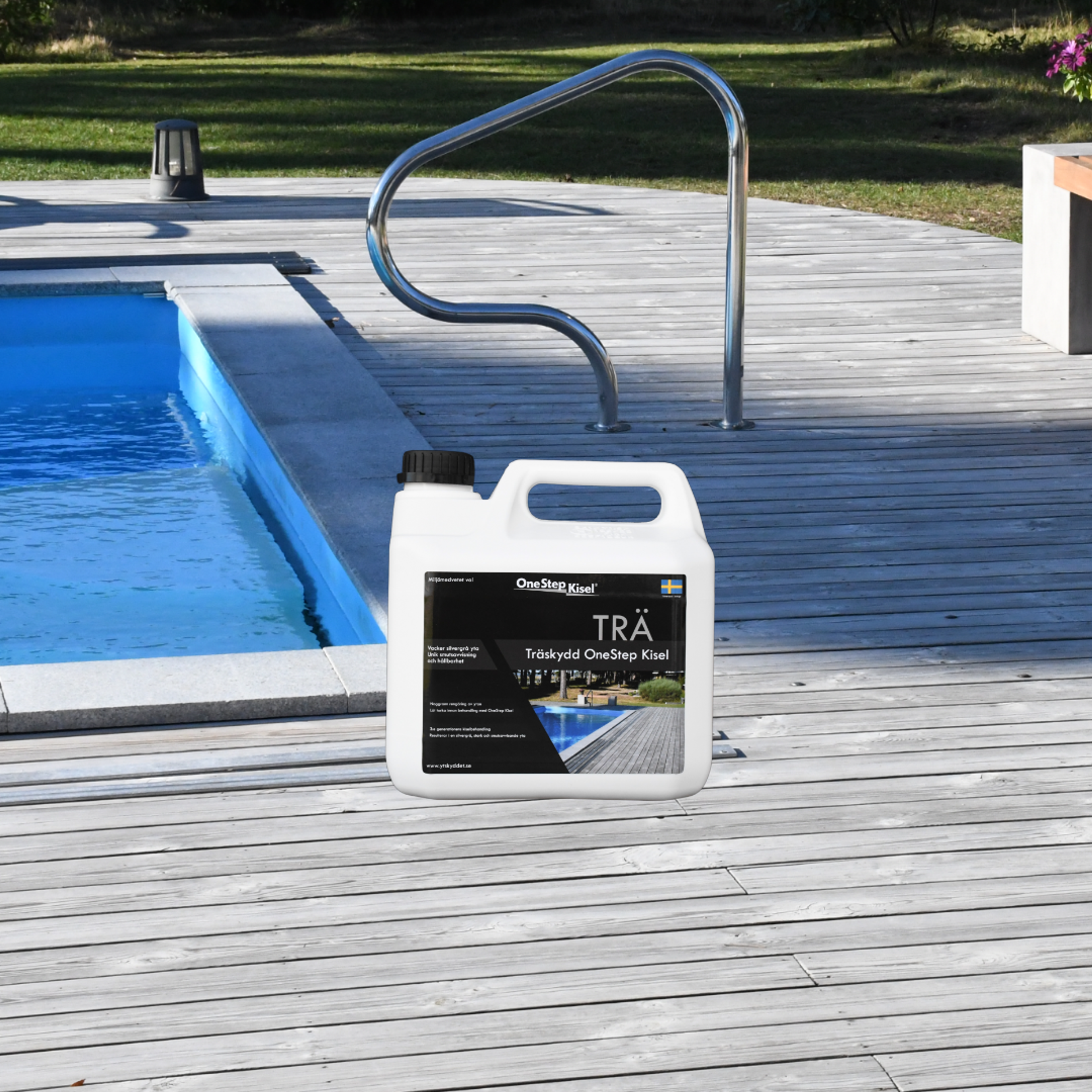 A white jug of Träskydd OneStep Kisel wood protection on a wooden deck by a pool.