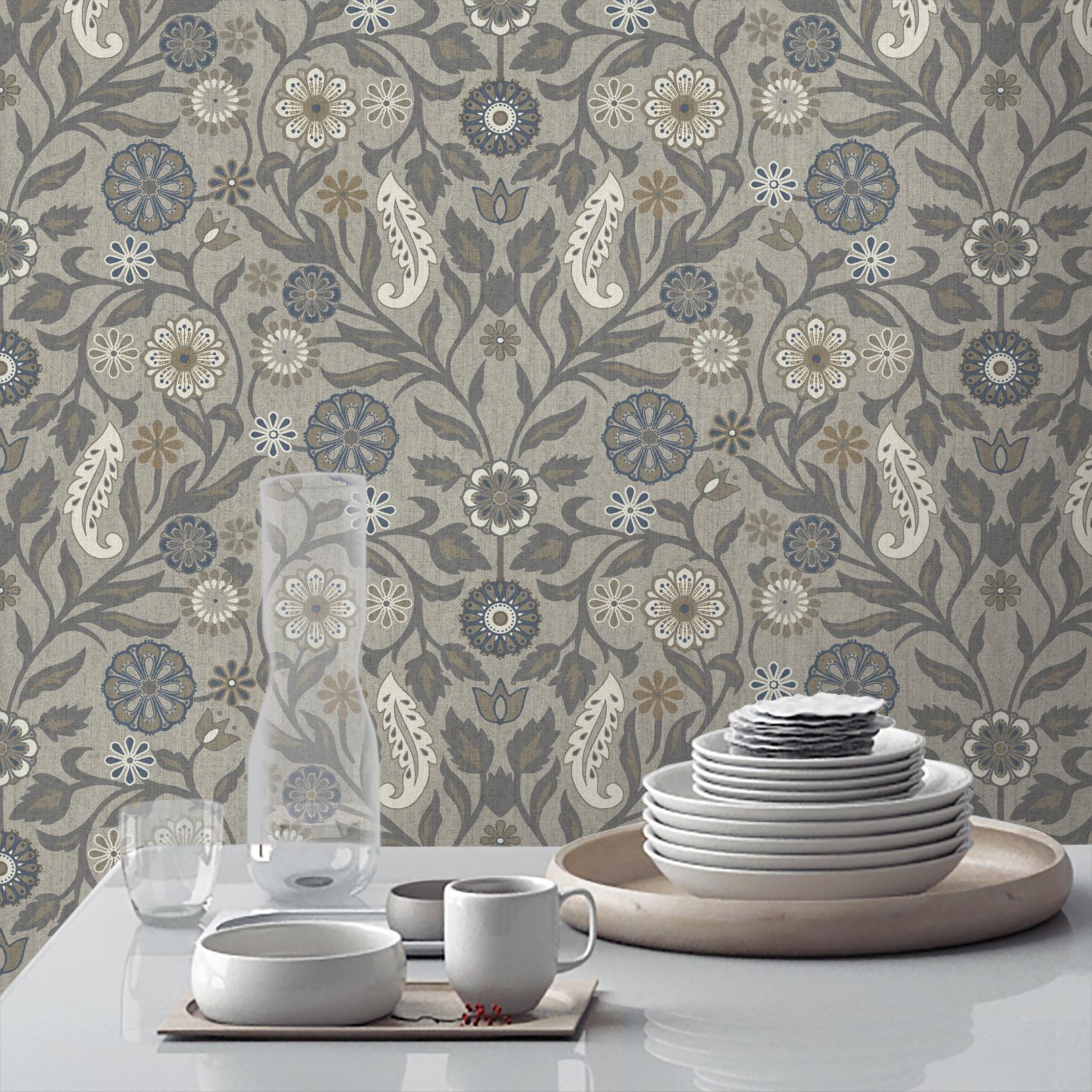 Detailed floral wallpaper in grey, blue, cream, and brown, behind a table with white dishes.